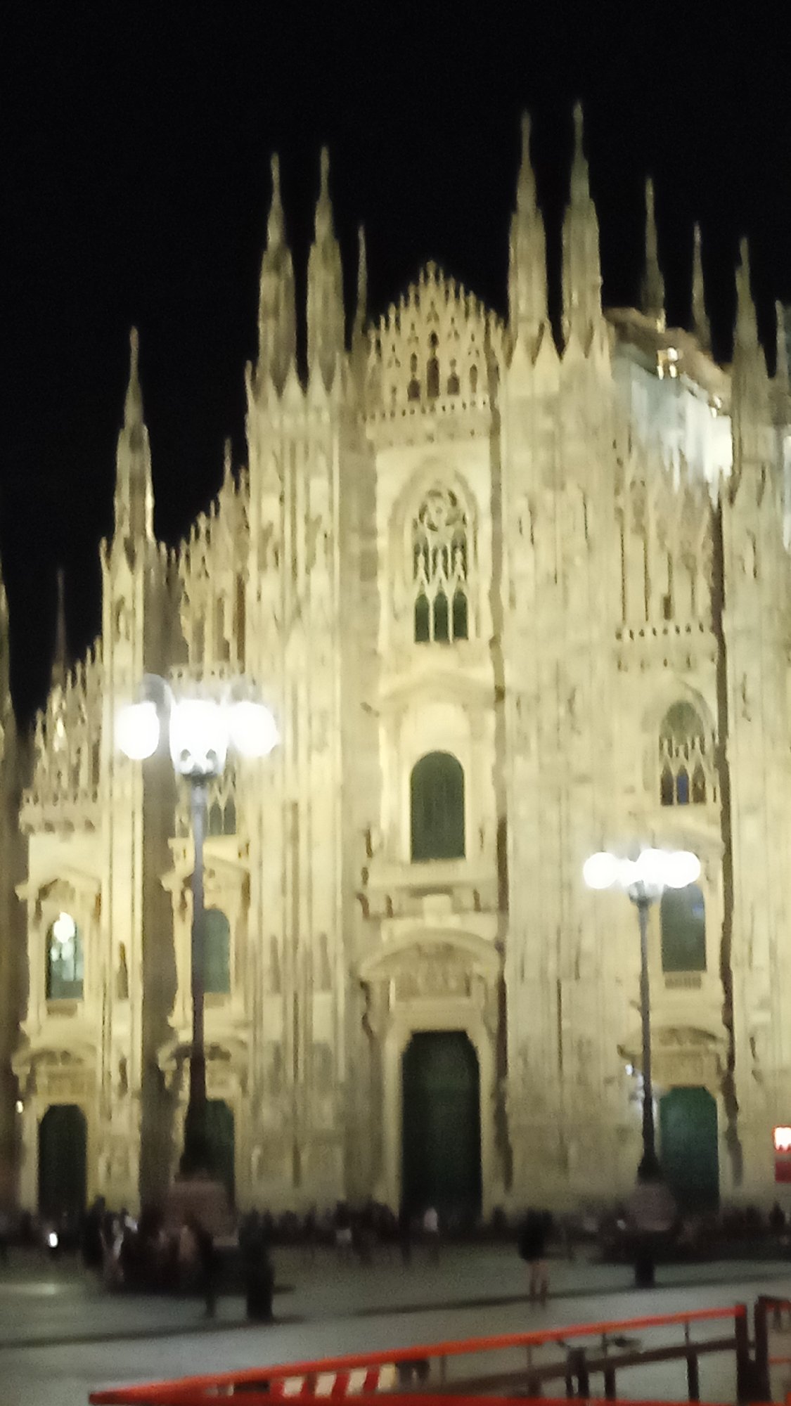 Milan's Duomo glowing under artificial lights at night