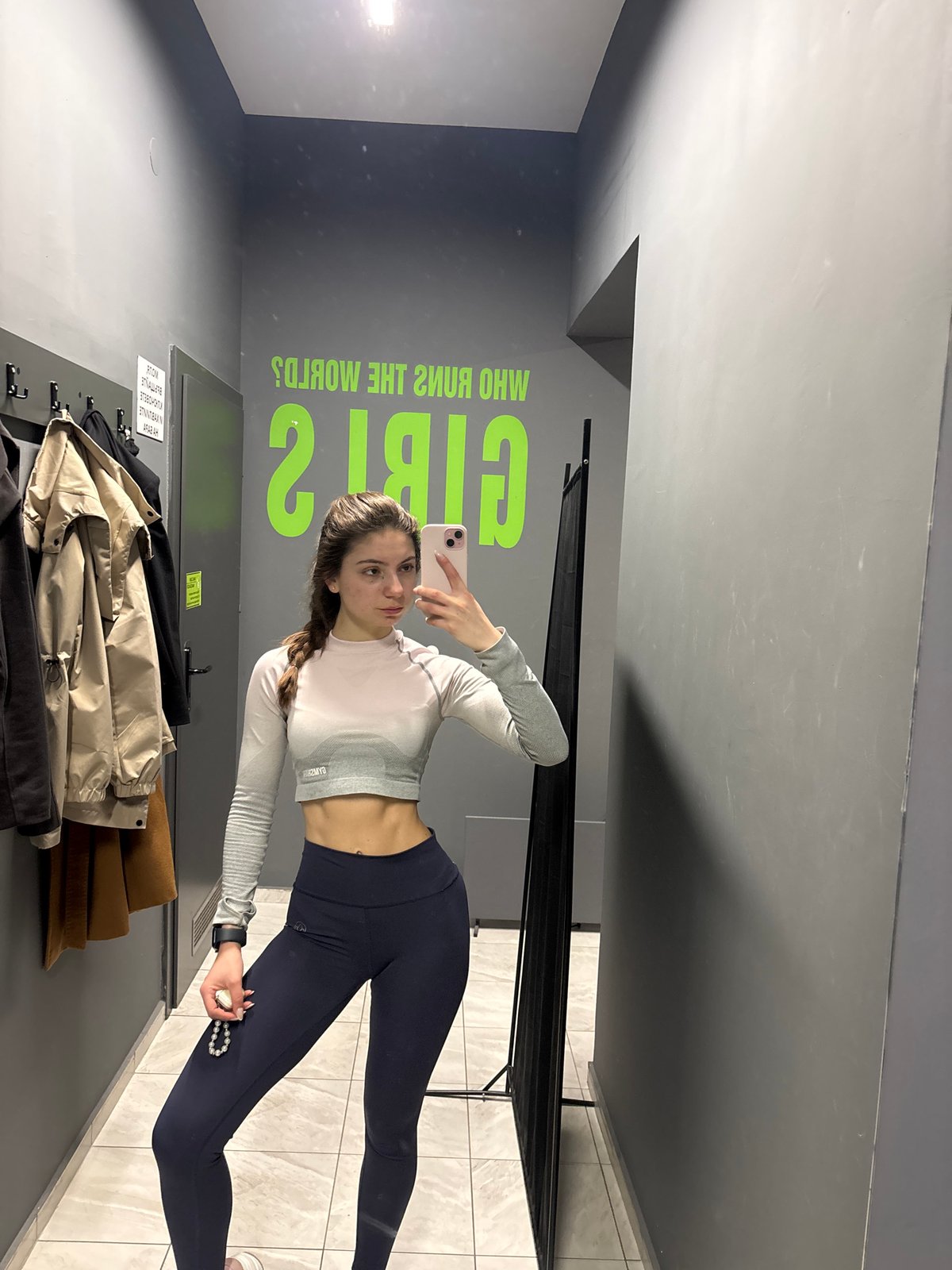 Woman takes gym selfie in motivational locker room