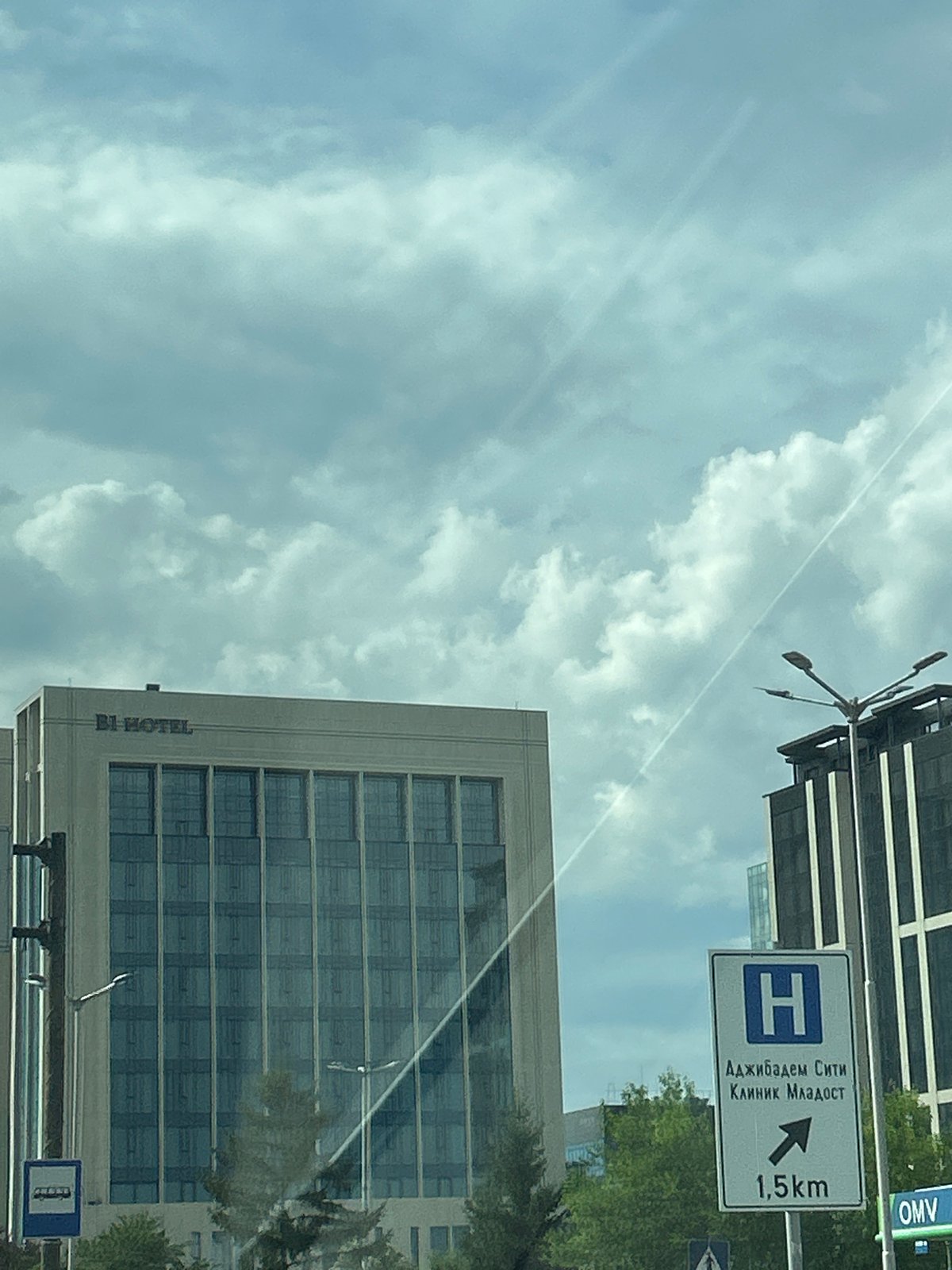Street-level tour of modern commercial Sofia on a cloudy afternoon