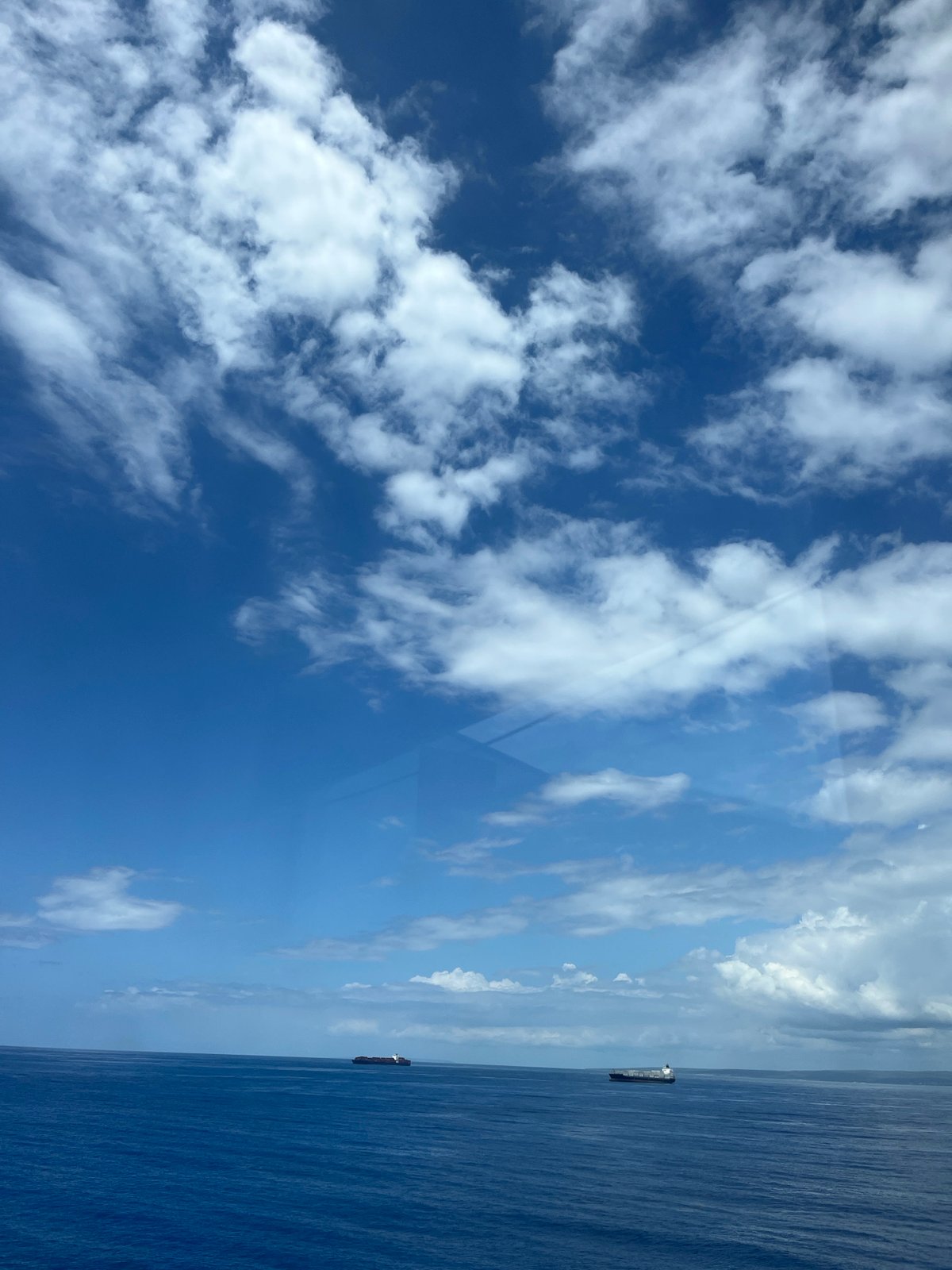 Two cargo ships spotted on calm ocean waters