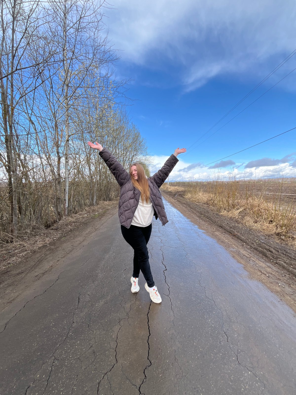 Woman takes selfies on cracked road in Opalevo, Russia