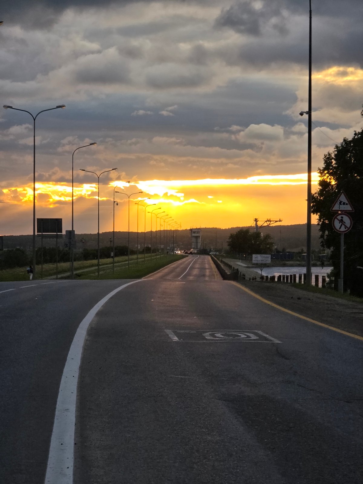 Chaikovsky at golden hour — roads, sunset skies, and street life