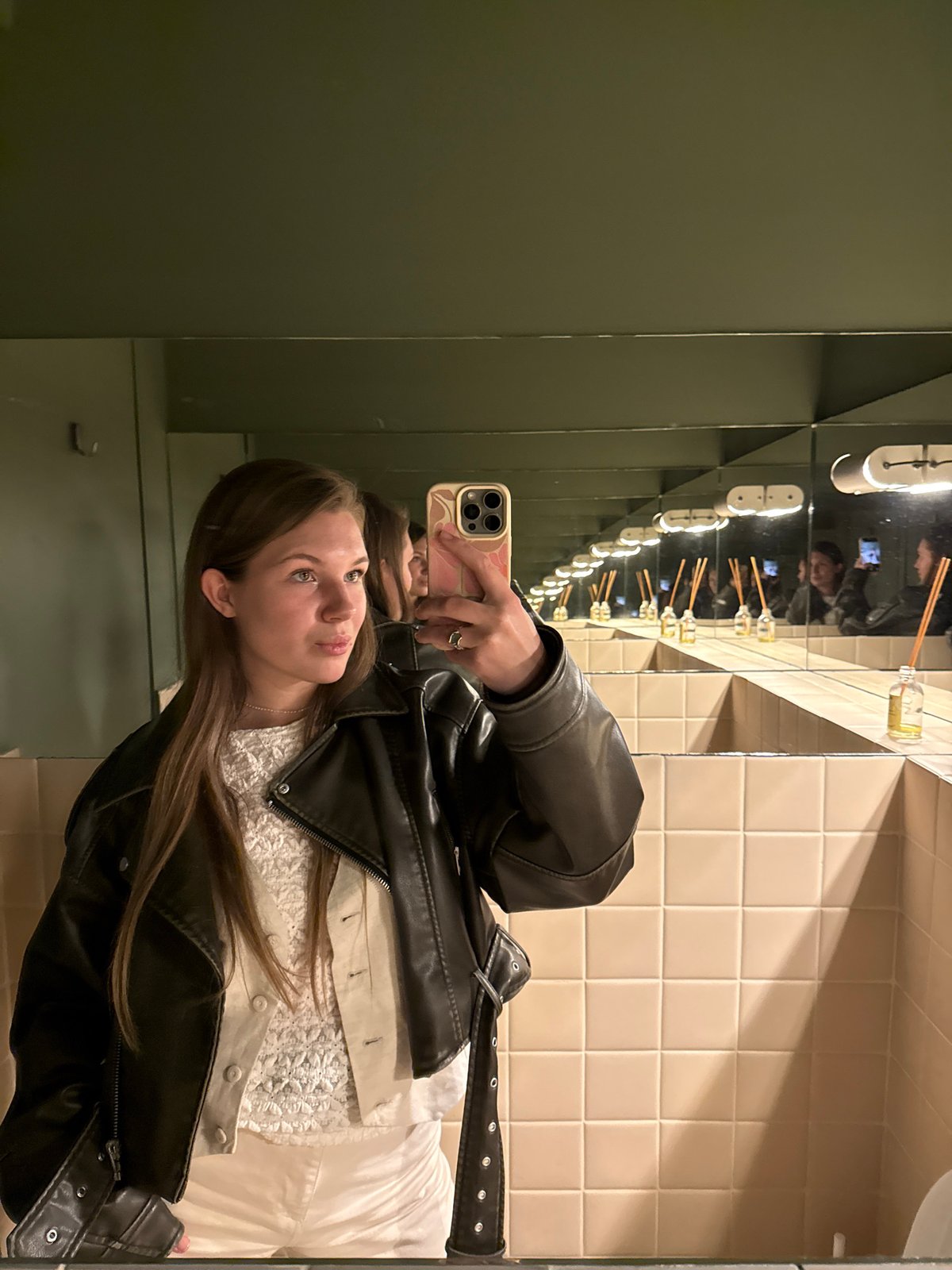 Person takes mirror selfies in Belgrade bathroom