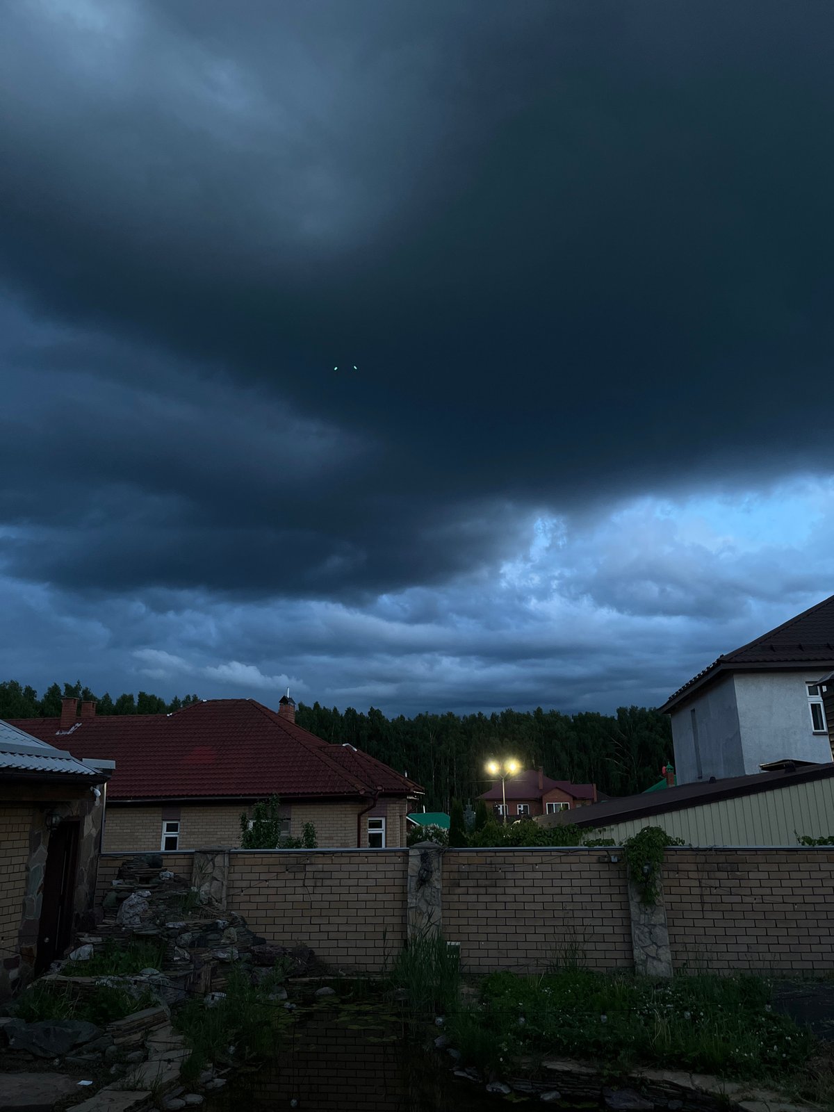Storm clouds gather over Orekhova, Russia at dusk