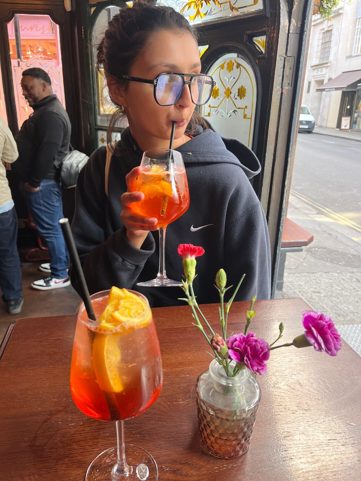 Person sits at table in London cafe during daytime