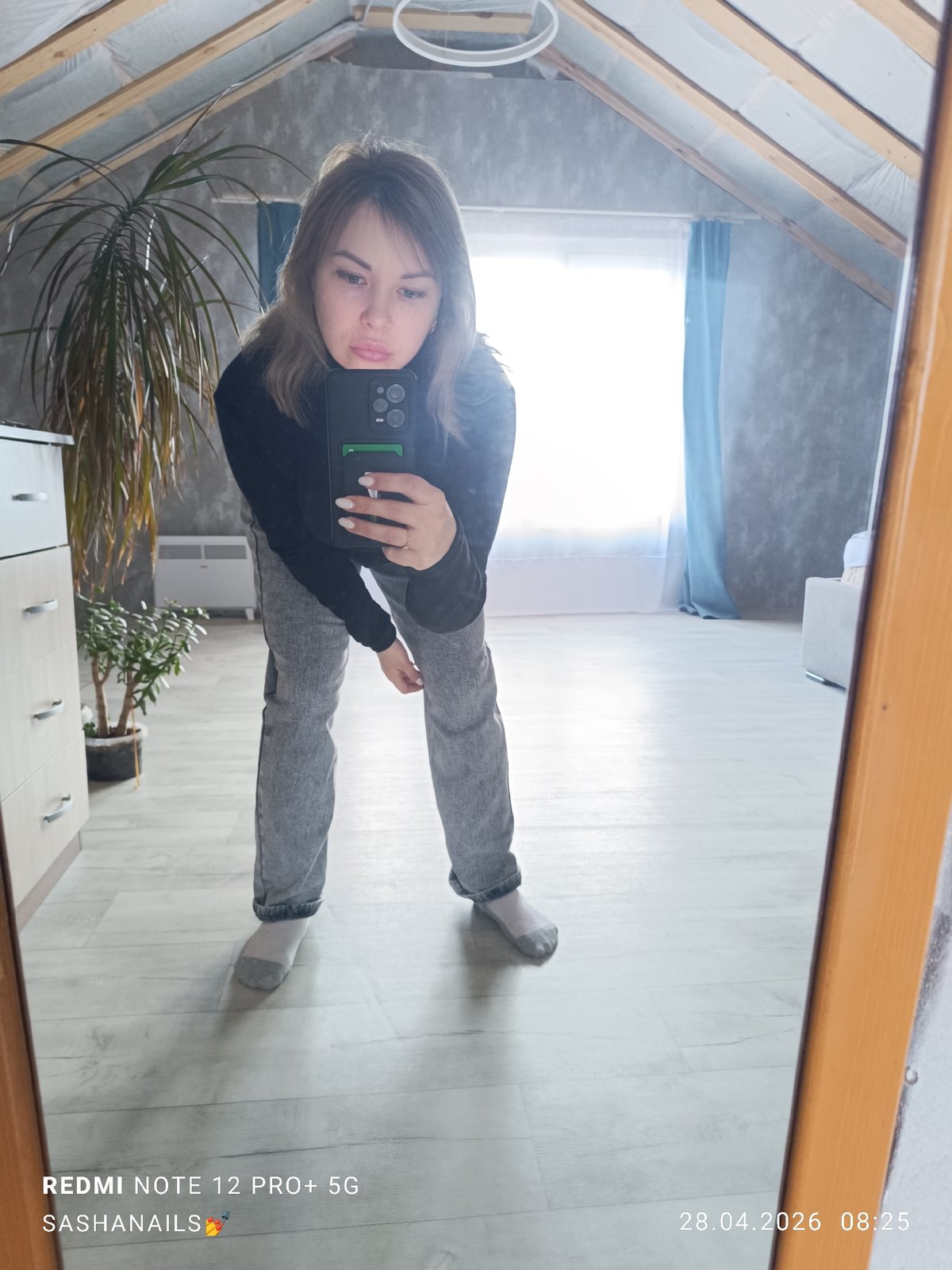 Woman takes mirror selfies in attic space, Chaikovsky Russia