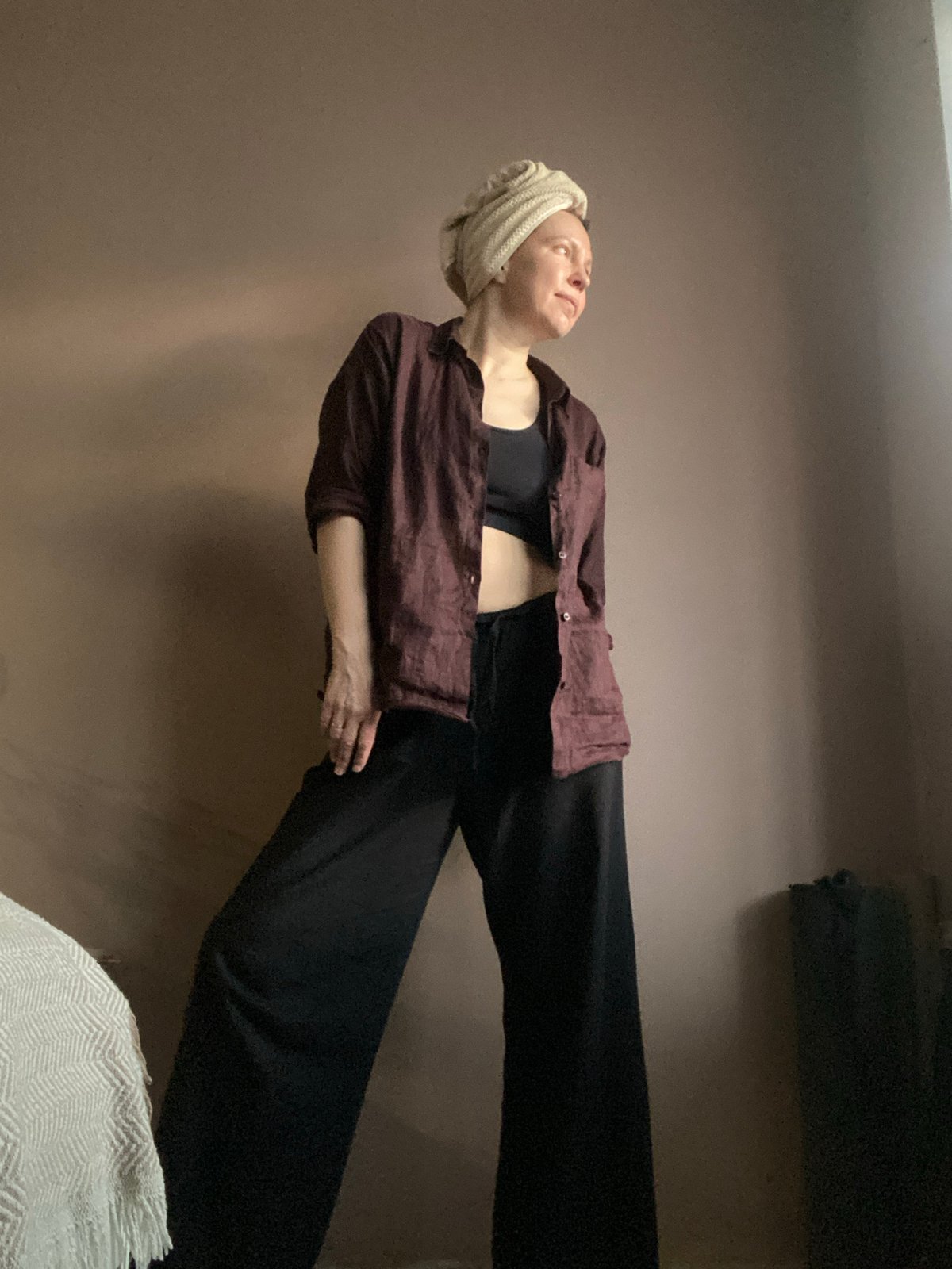 Woman photographs herself in residential setting in Chaikovsky, Russia