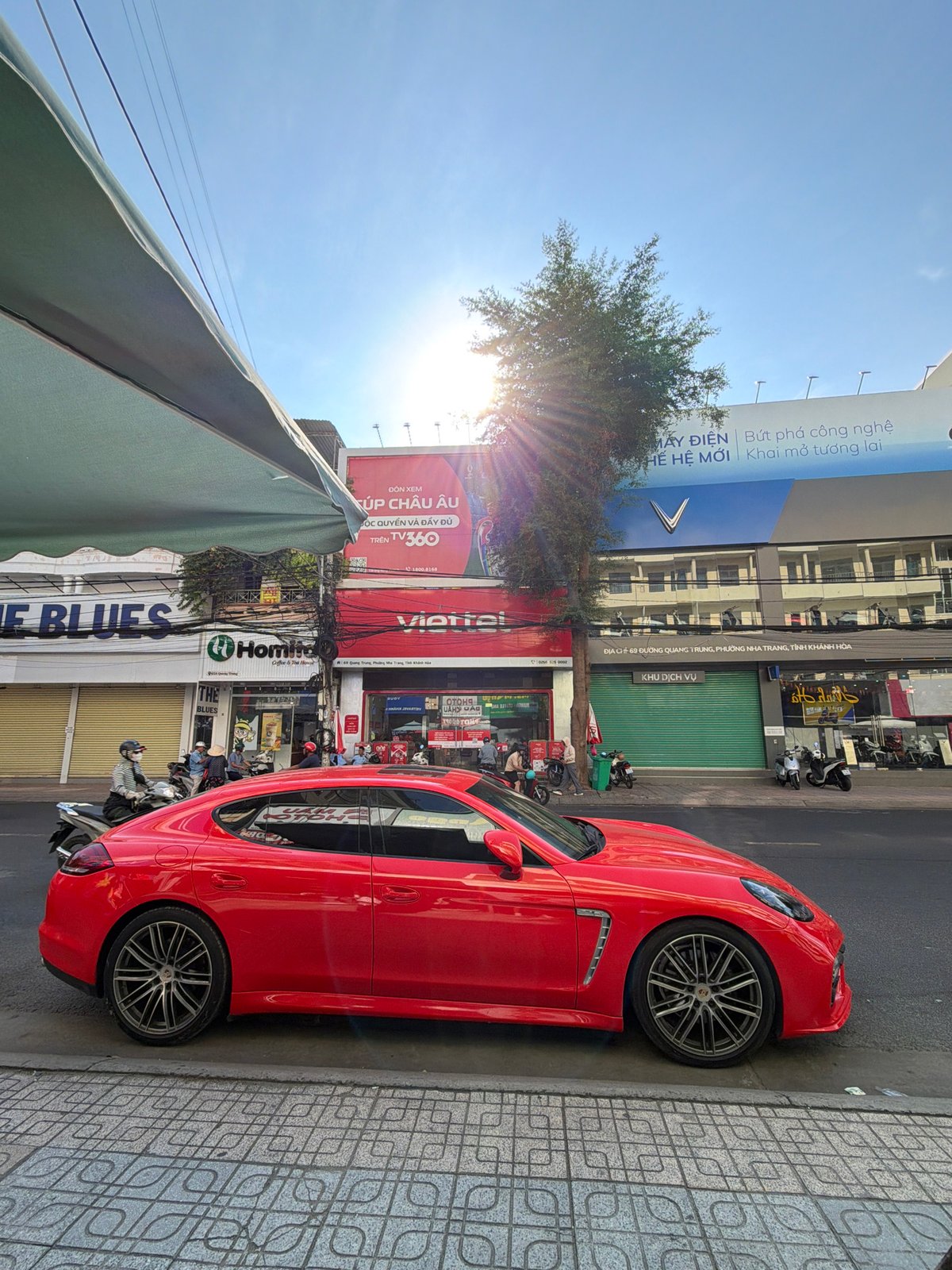 Red Porsche, monks, and street vendors on a Nha Trang corner
