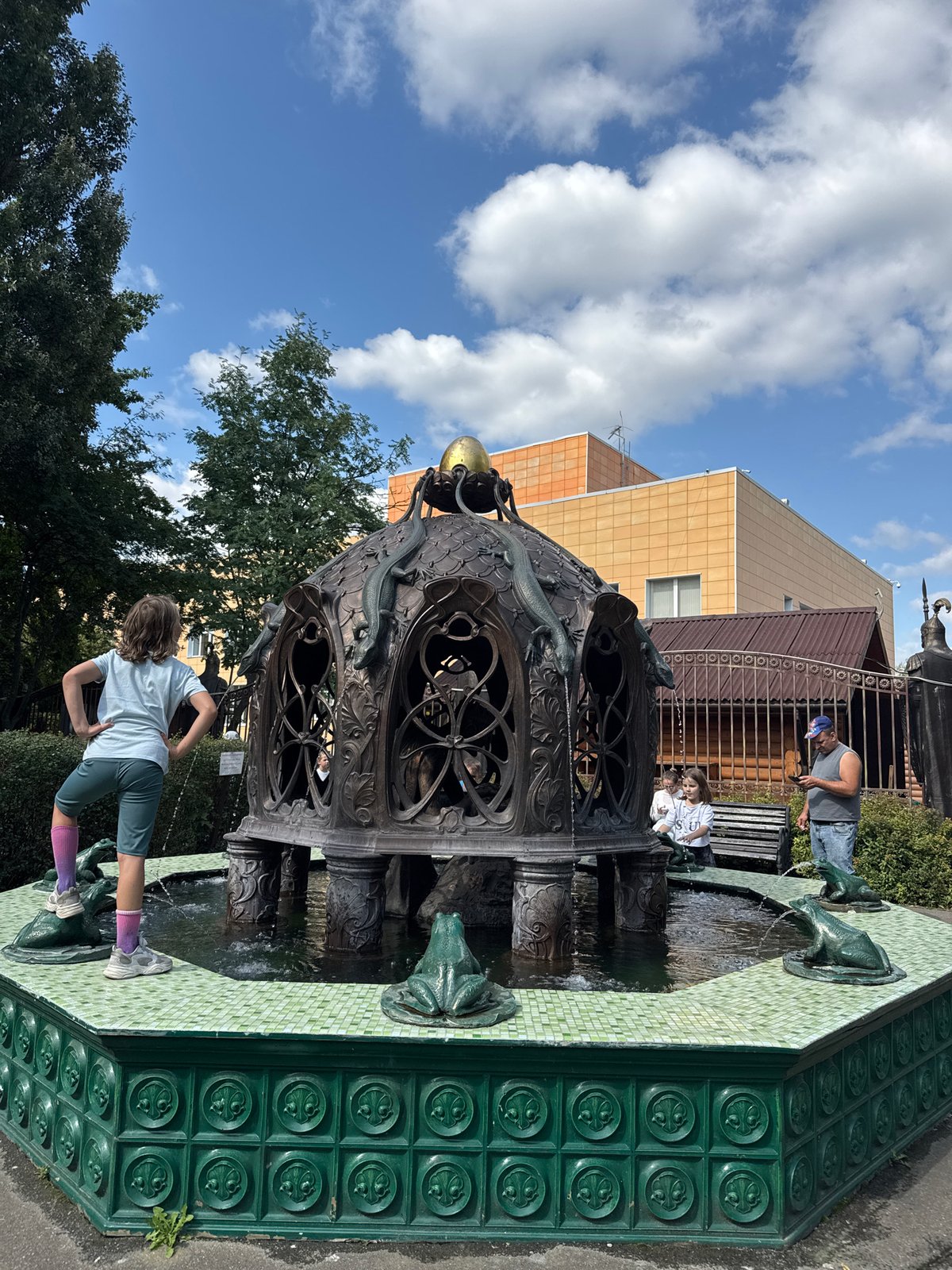 Bronze fountain and chain-wrapped oak tree at Sovkhoza imeni Lenina