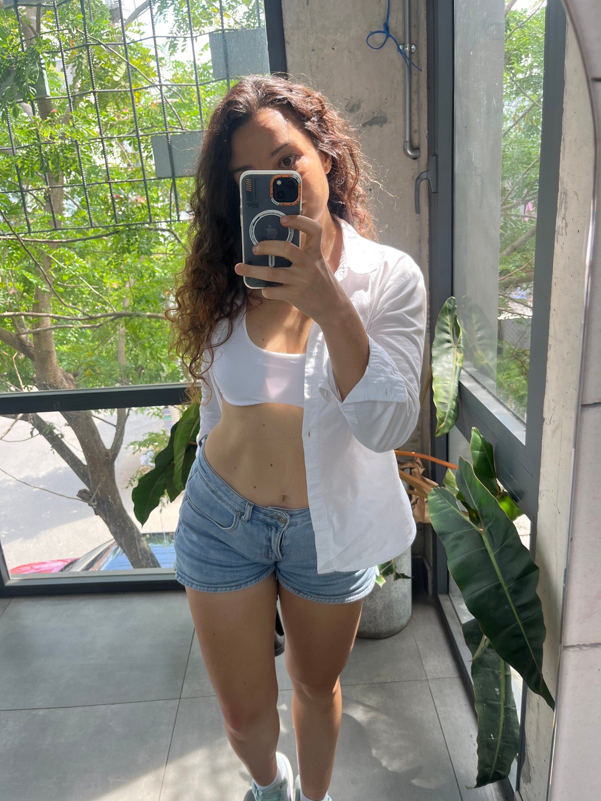 Morning mirror selfies in apartment overlooking Vietnam greenery