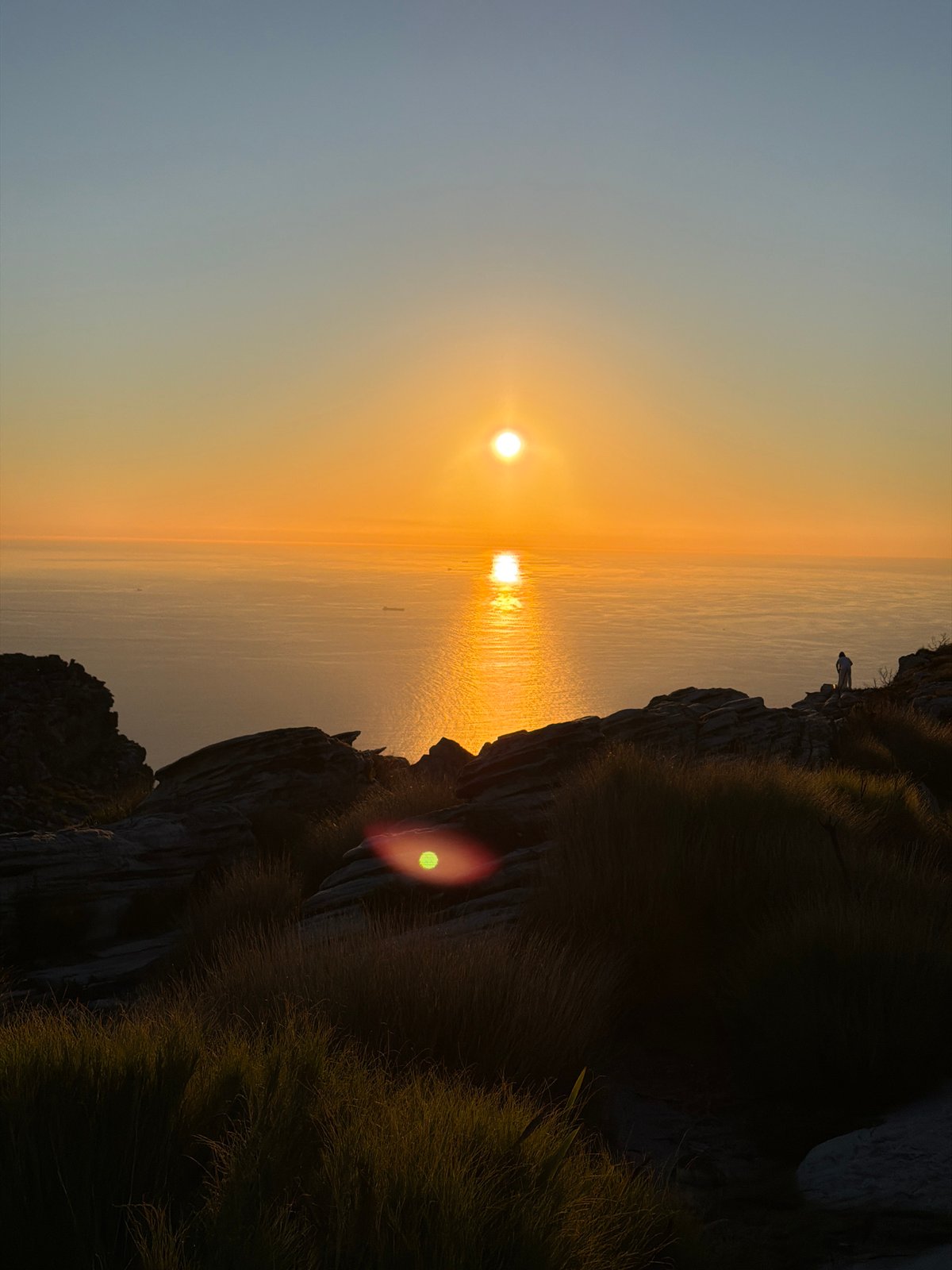 Sunset photographed from Cape Town clifftop overlooking ocean