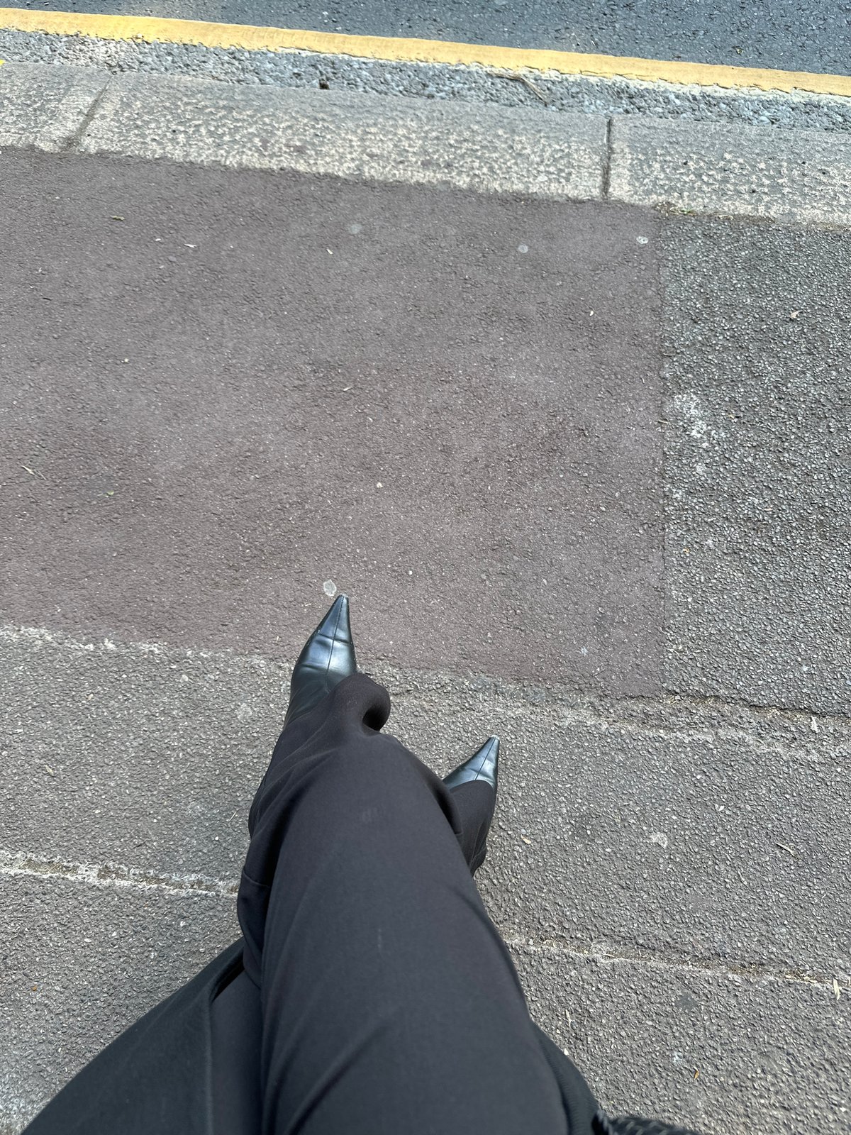 Person in black attire observed standing on London street