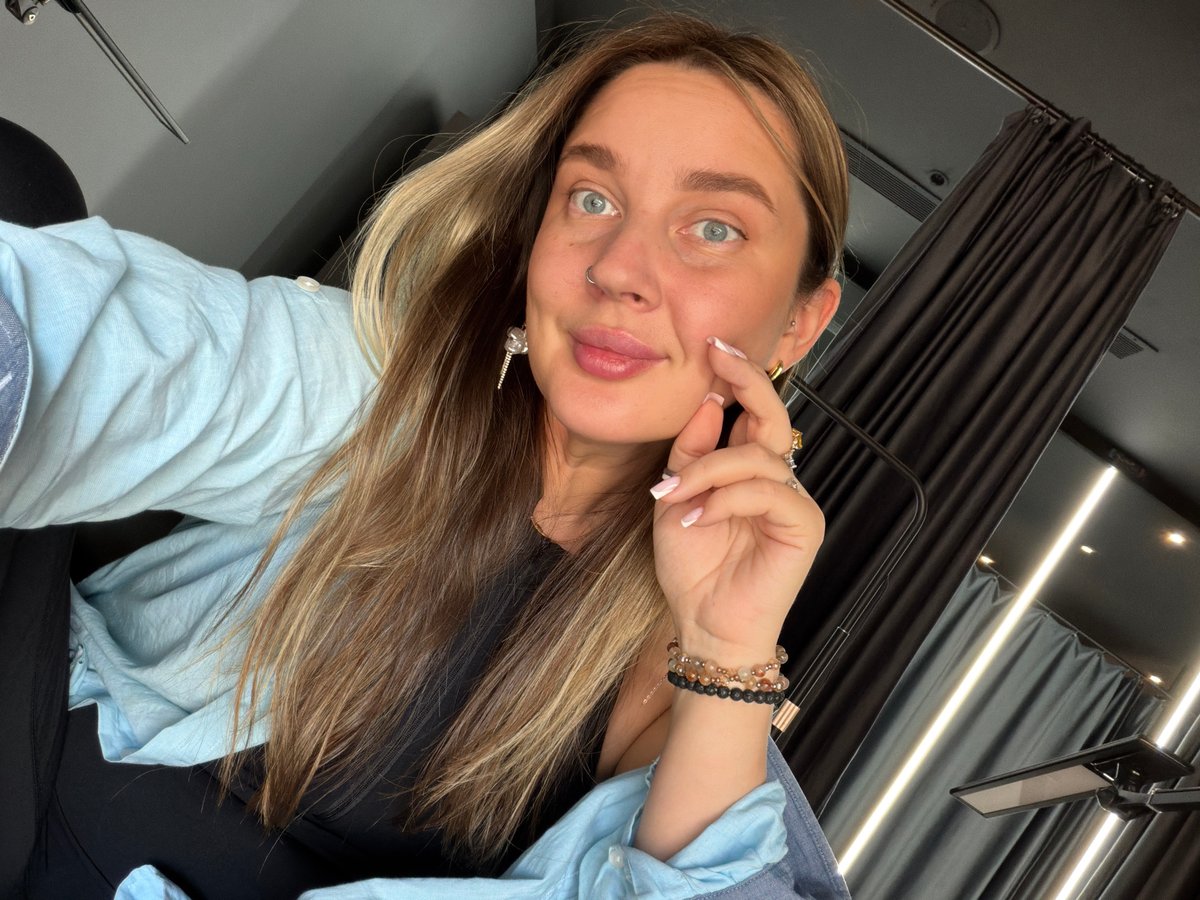 Woman takes selfies in Moscow wearing light blue shirt