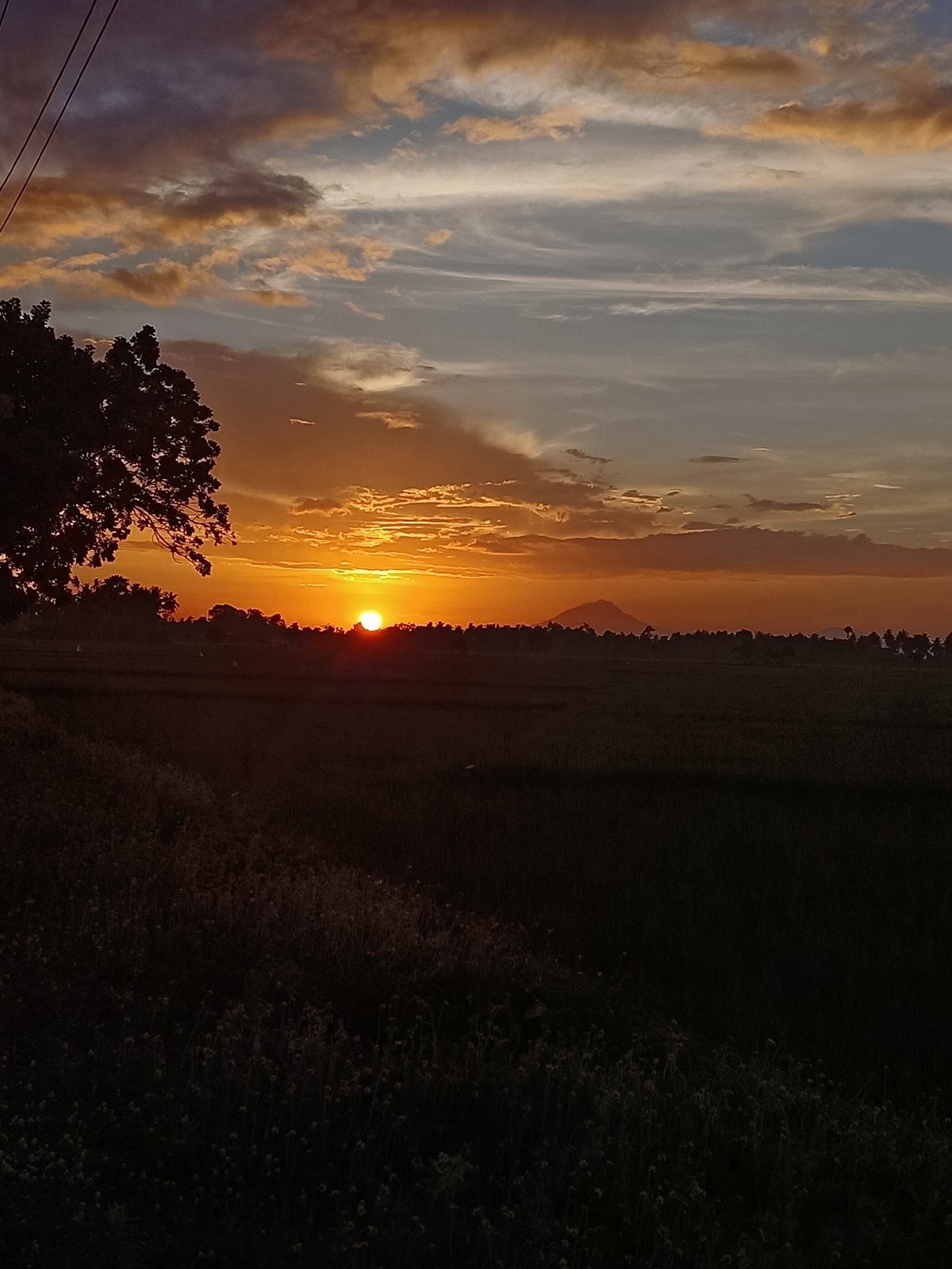 Sunset over the rural ridgeline of Kampung Jumpa, Indonesia