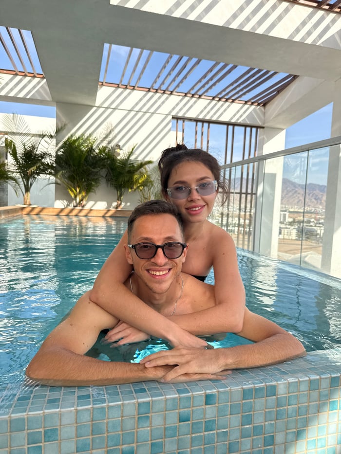 Couple enjoys luxury rooftop pool afternoon in Eilat