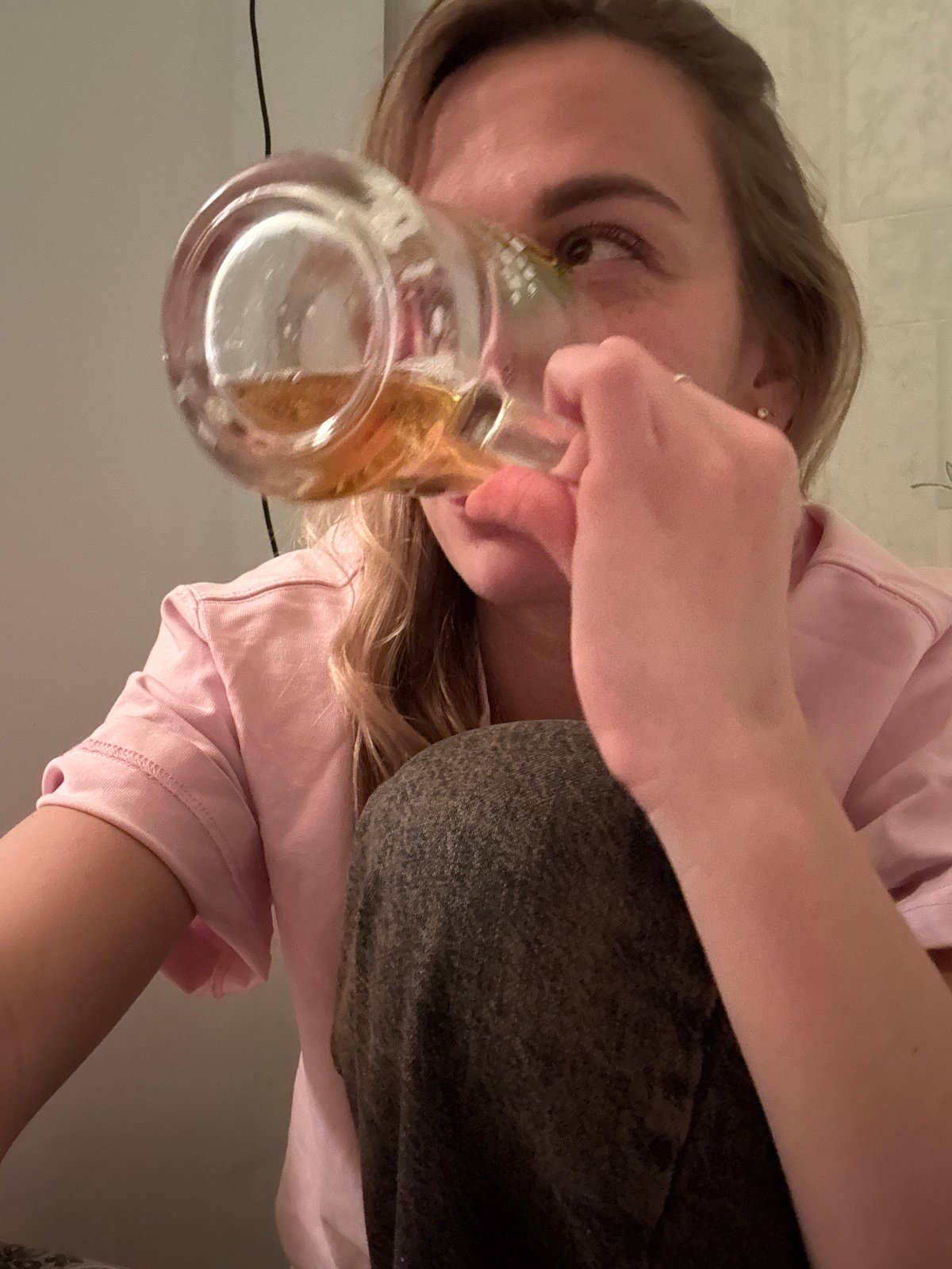 Woman drinks from glass mug in Ust-Ilimsk