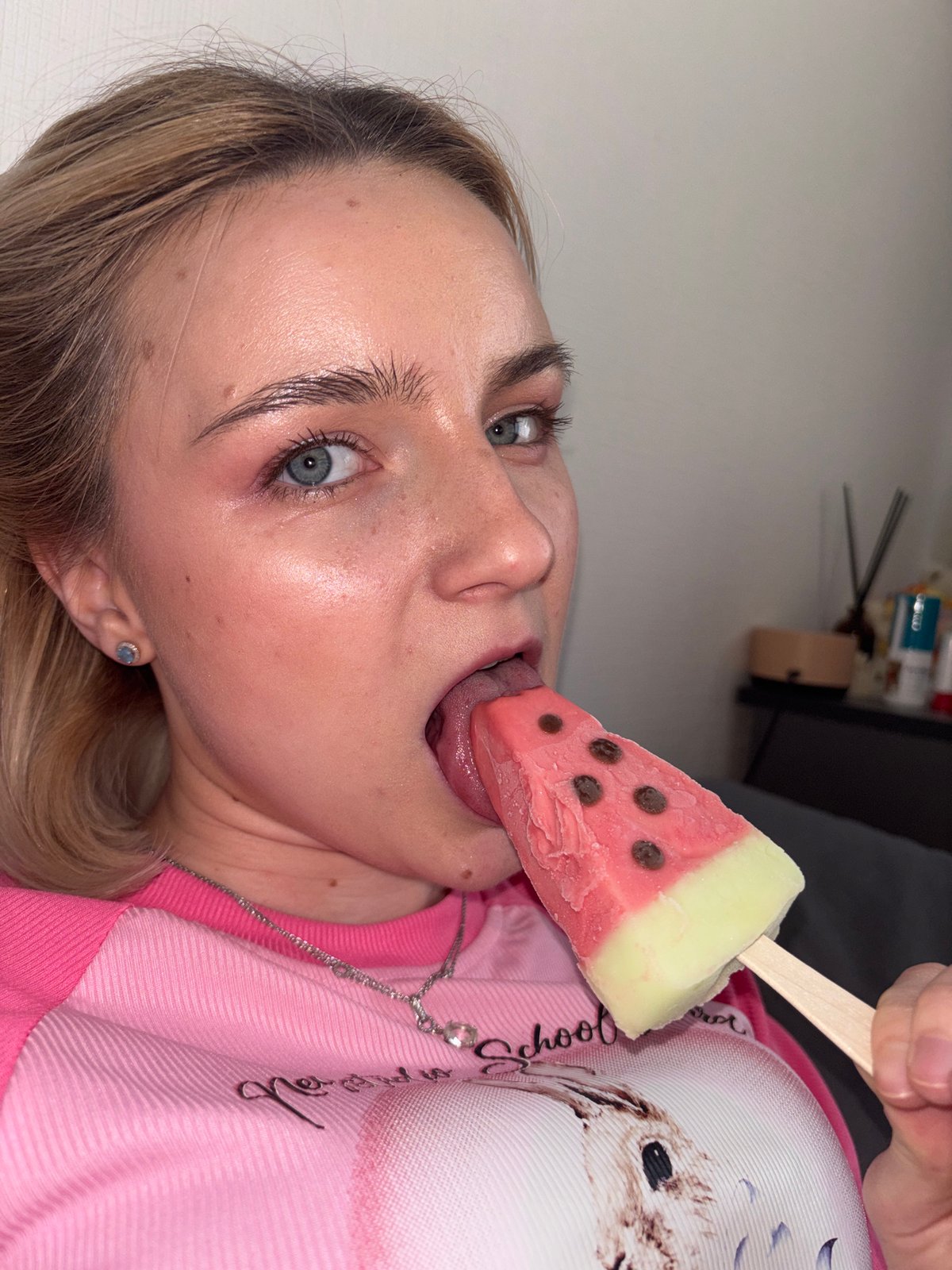 Young person enjoys watermelon popsicle in Sinyavino, Russia
