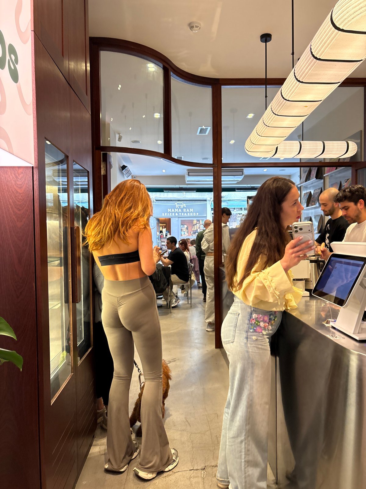 Dog accompanies owner through Kadıköy retail space during afternoon visit