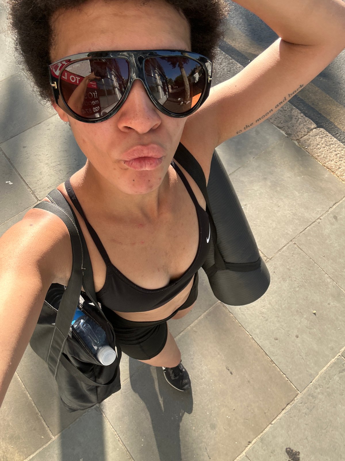Sunny London afternoon: yoga gear, sidewalk stroll, selfie stop.