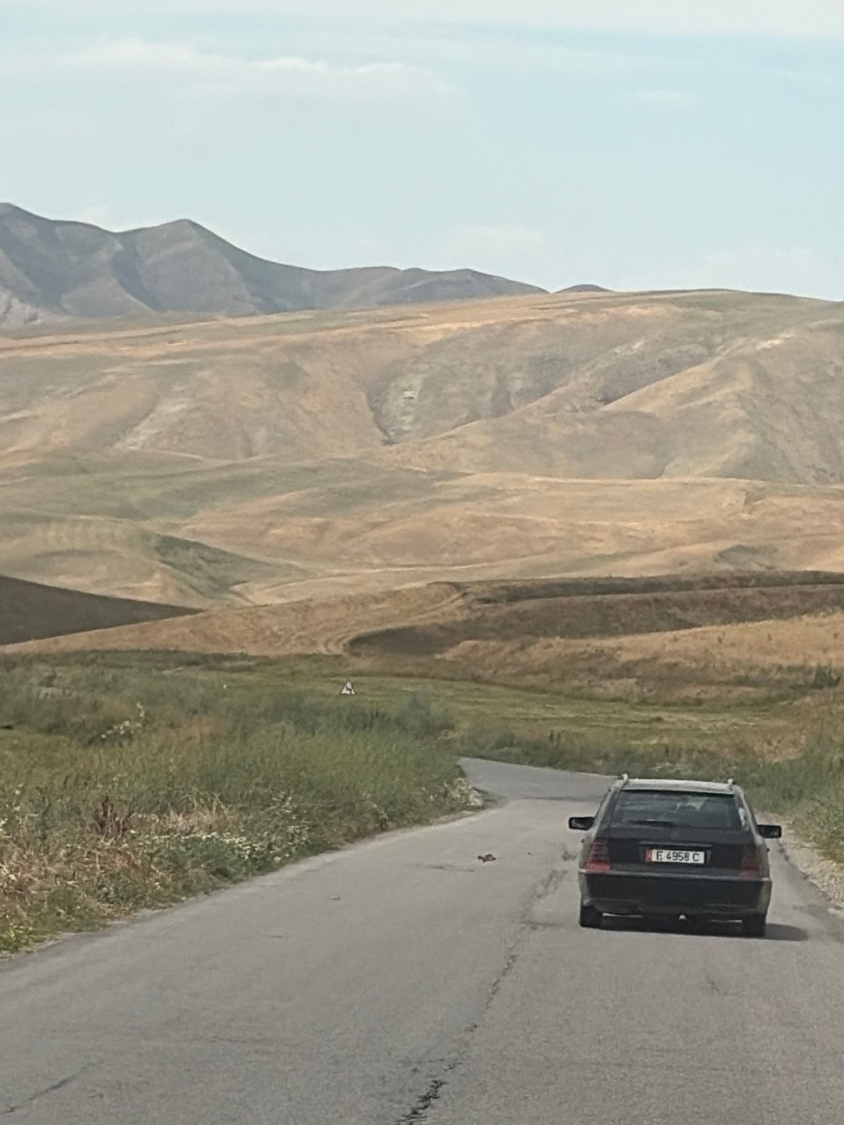 Rural mountain valley life: roads, farms, and open hillsides