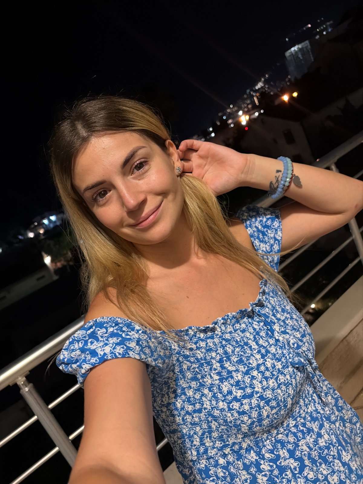 Balcony evening in Budva with city lights and selfies