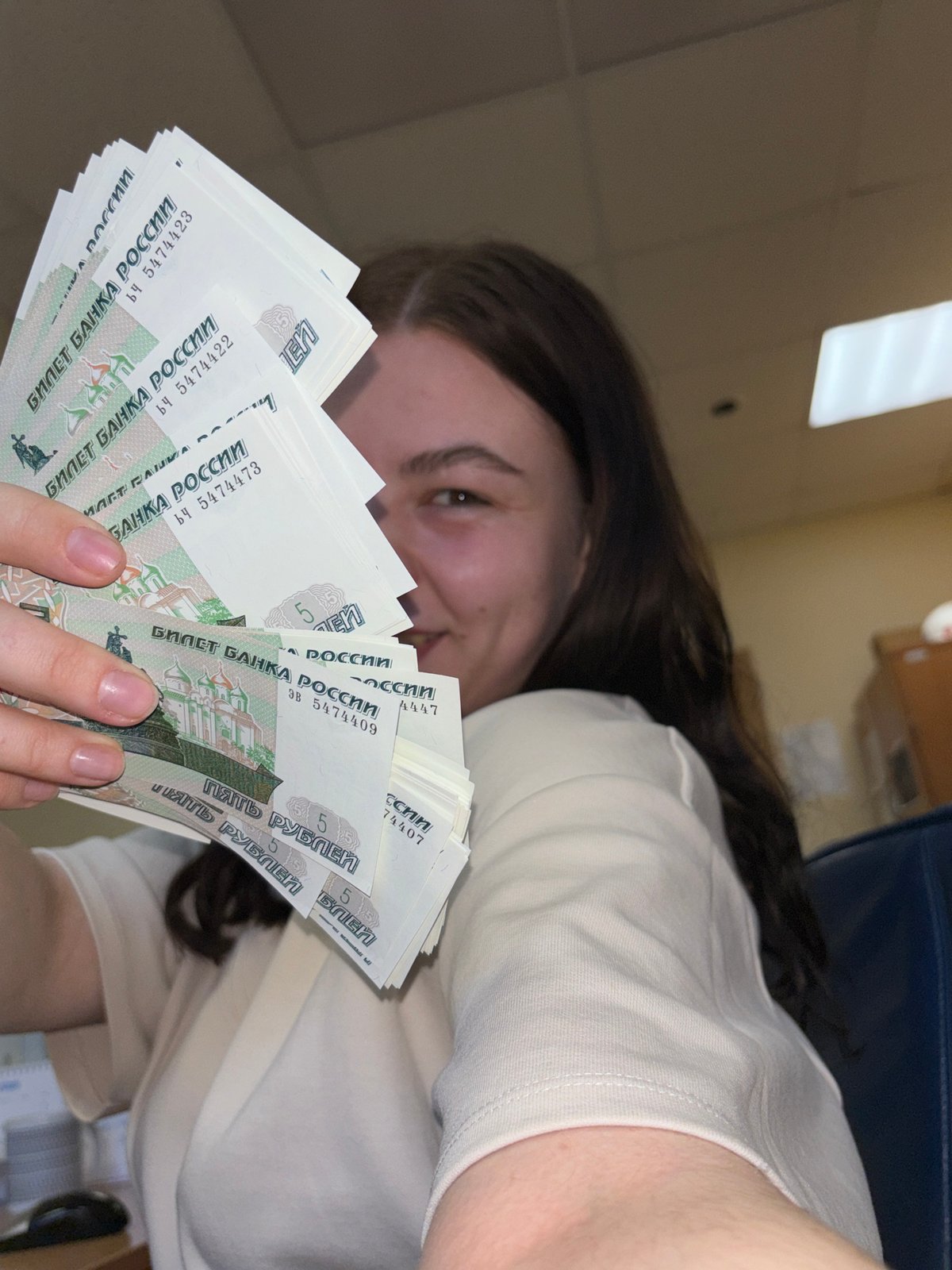 Woman handles Russian rubles in Perm office setting