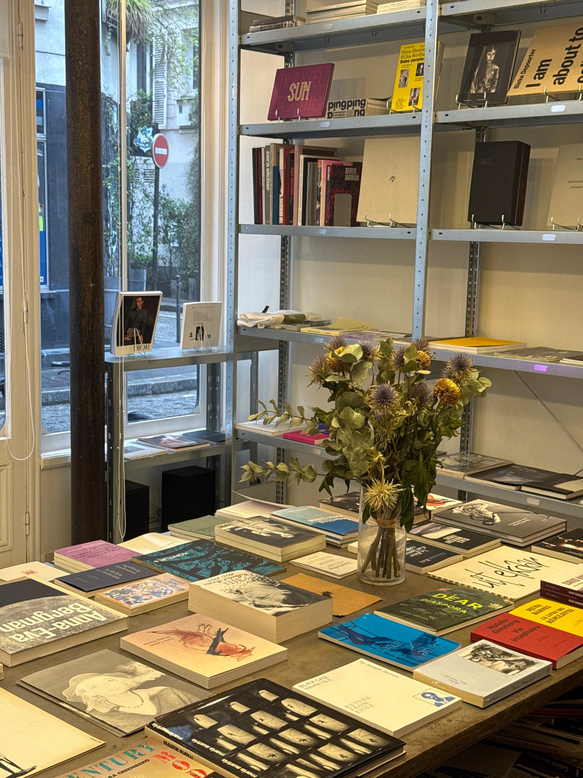 Paris bookstore interior captured with books and dried flowers
