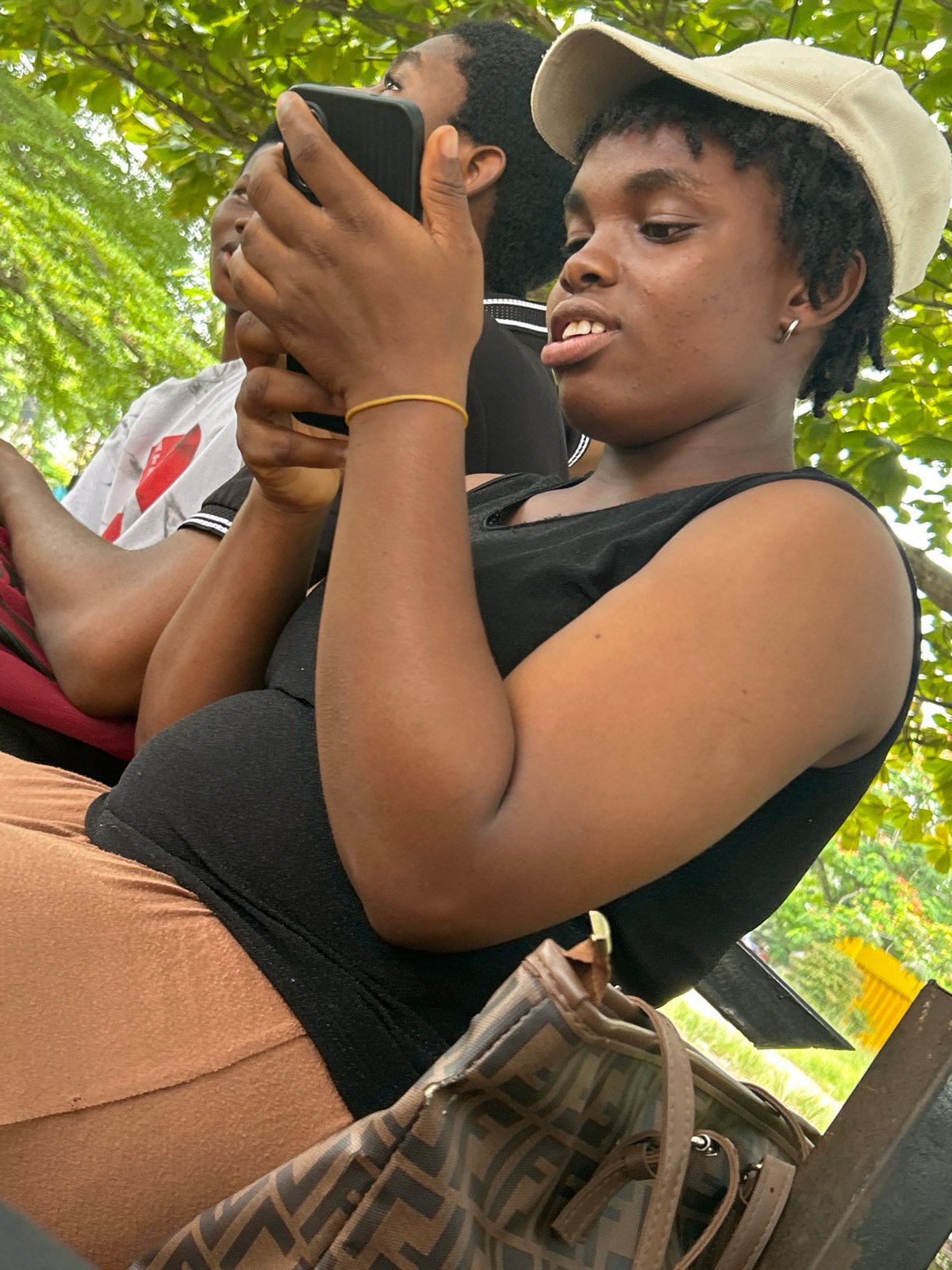 Casual afternoon gathering under green canopy in Ihiagwa, Nigeria