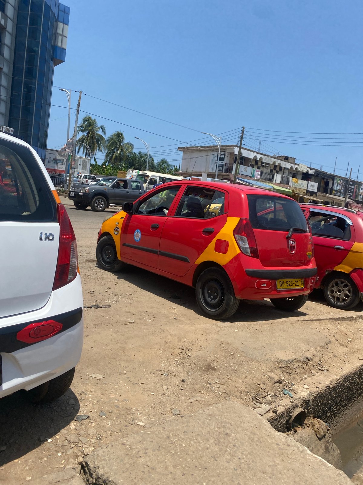 Midday street life documented across commercial Accra