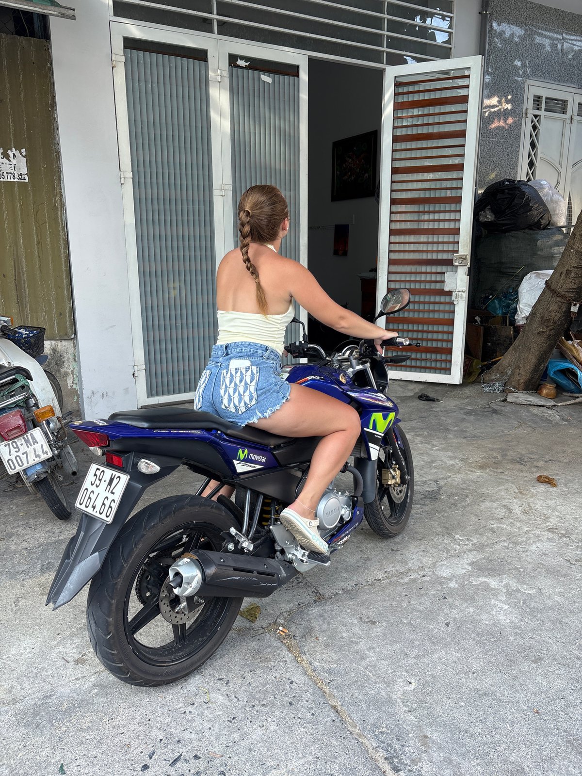Woman poses with Yamaha motorcycle in Nha Trang