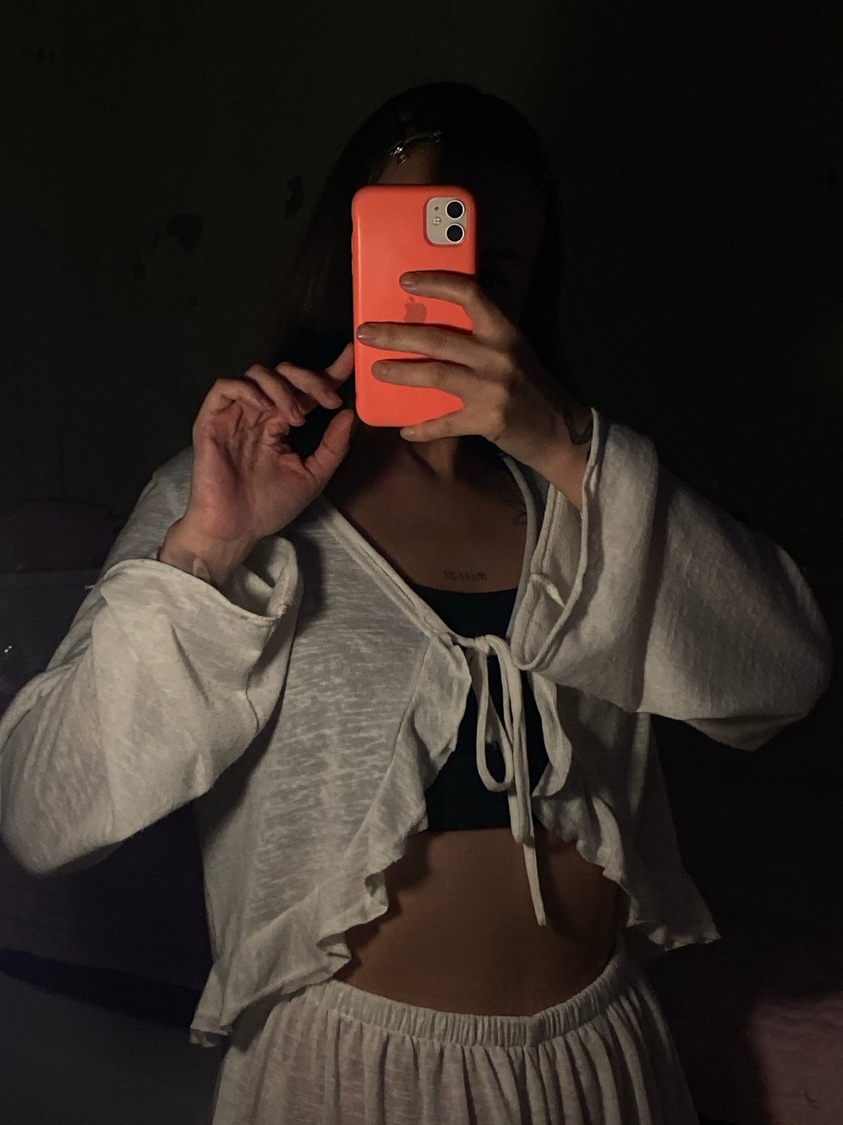 Woman takes mirror selfies in dimly lit Votkinsk interior