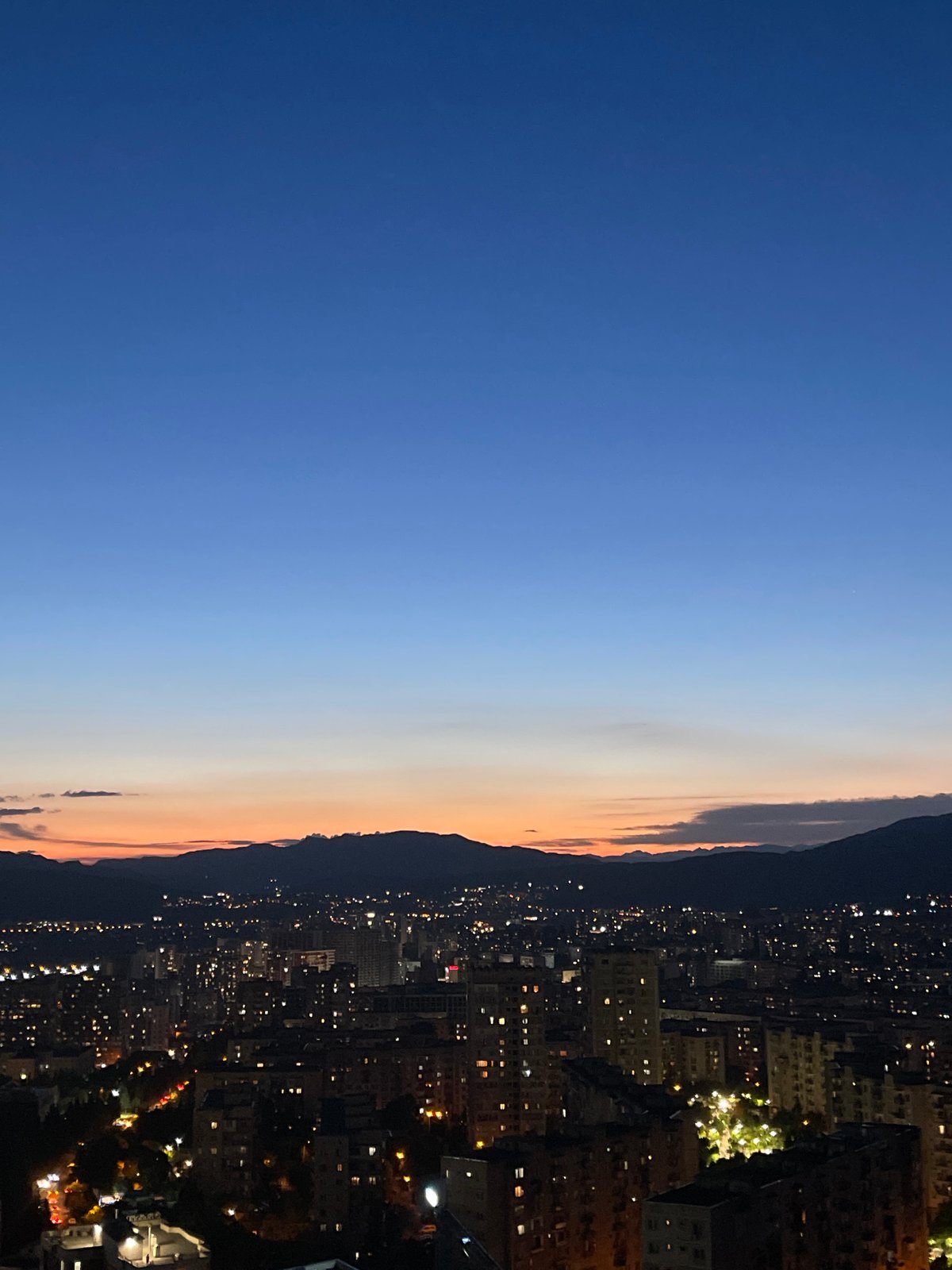Twilight cityscape views across Tbilisi from elevated balcony