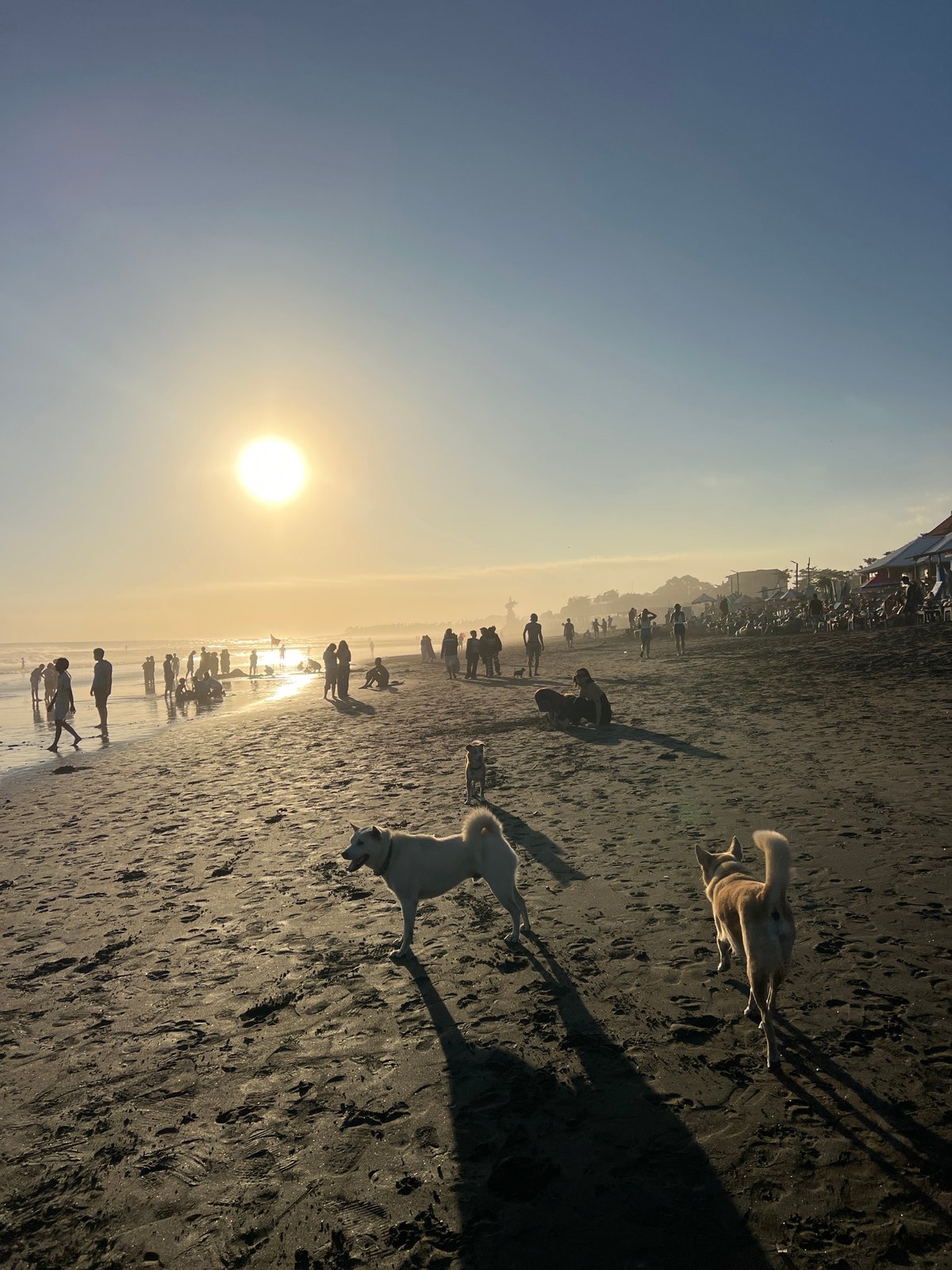 Kuta Beach at golden hour — surf, soccer, and crowds
