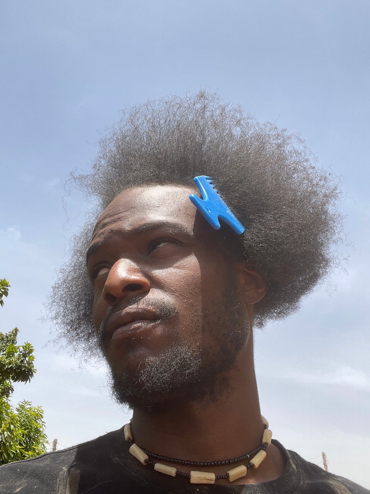 Man with blue comb photographed in Jos, Nigeria