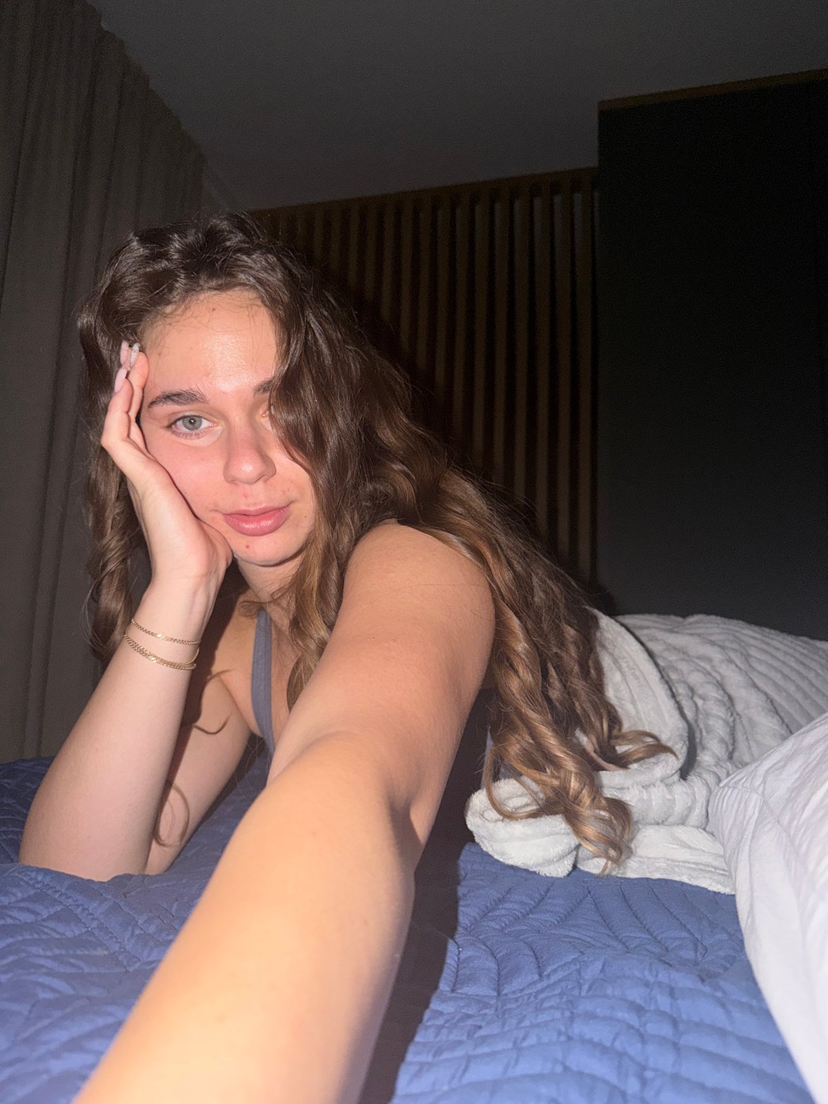 Bedroom selfie series on a blue quilted bed