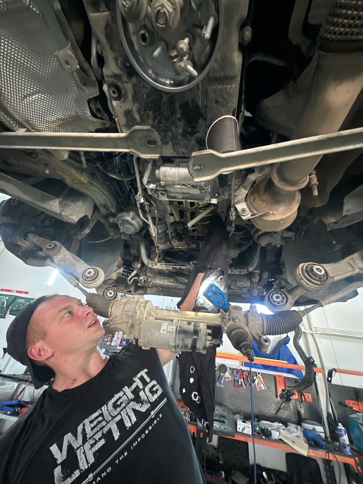 Mechanic services Mercedes while grilling lunch in Blagoveshchensk garage