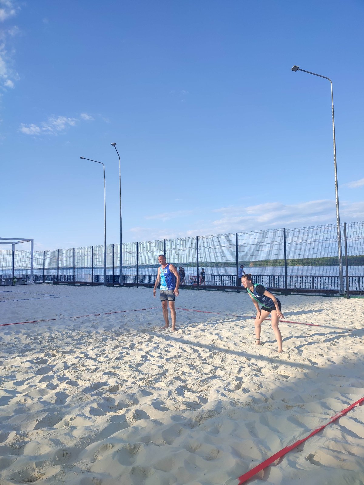 Beach volleyball games and jet skiing captured during afternoon