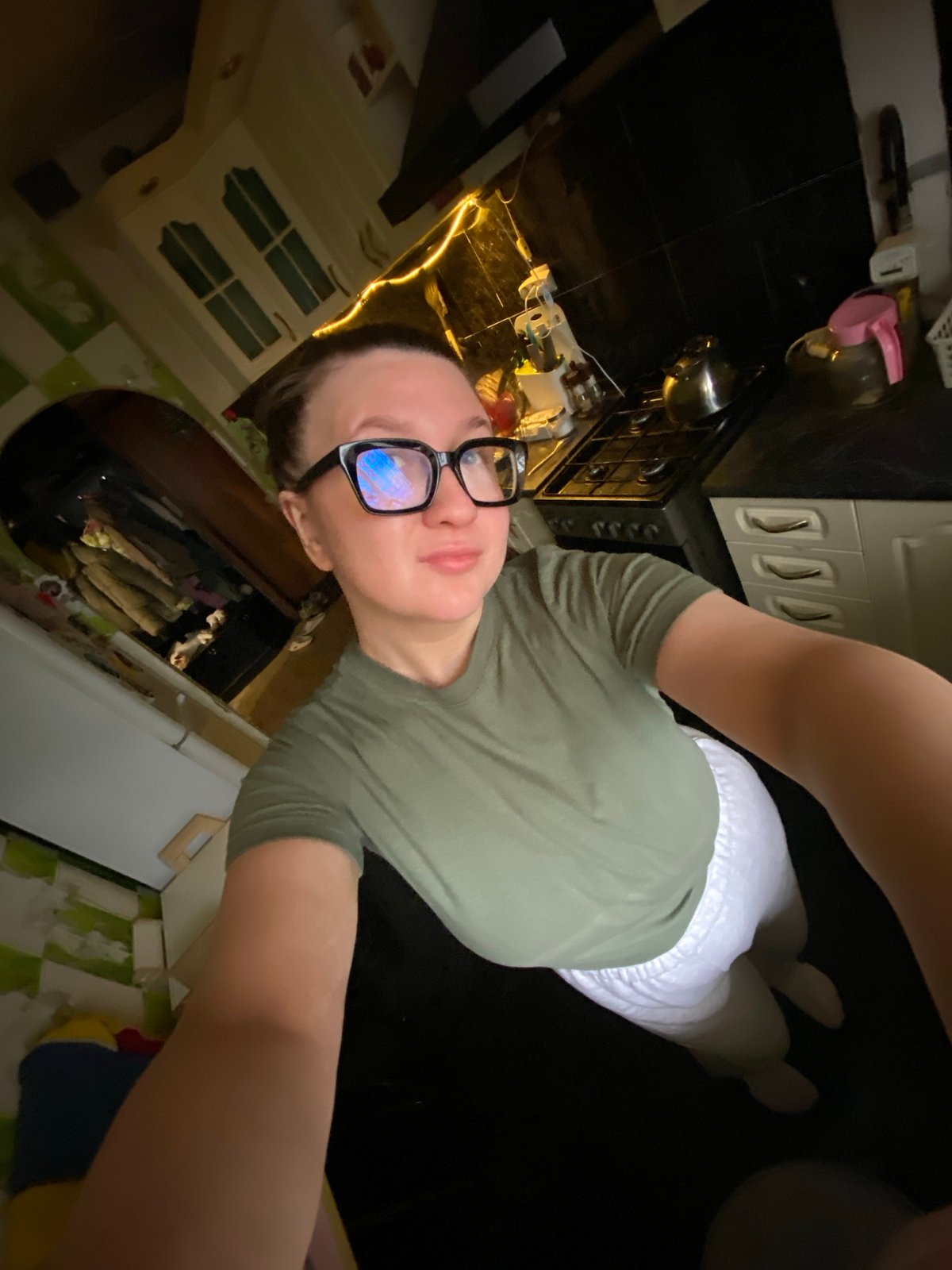 Person Takes Kitchen Selfie Wearing Green Shirt and Glasses