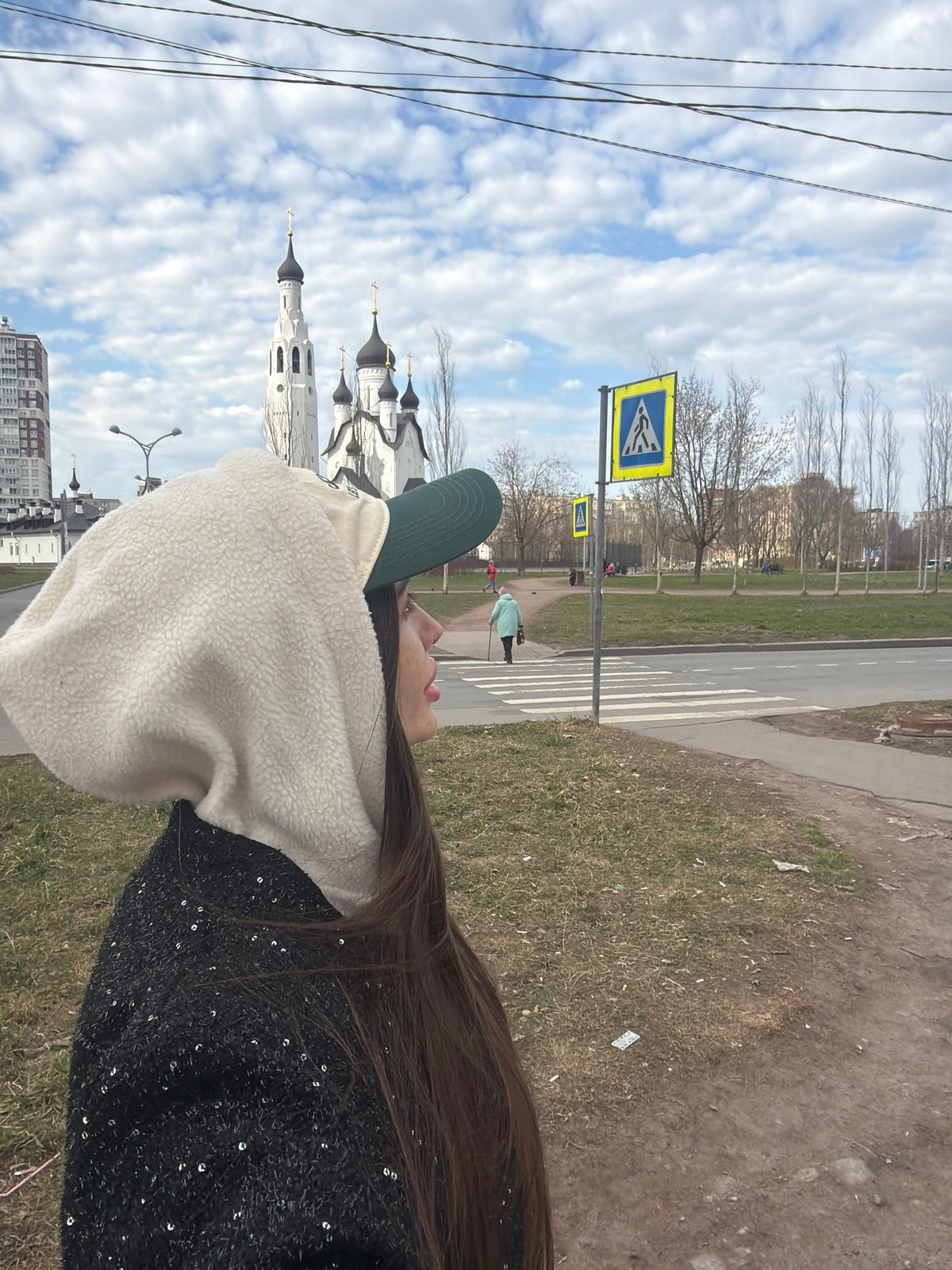 Person observes Orthodox church during afternoon stroll in Saint Petersburg