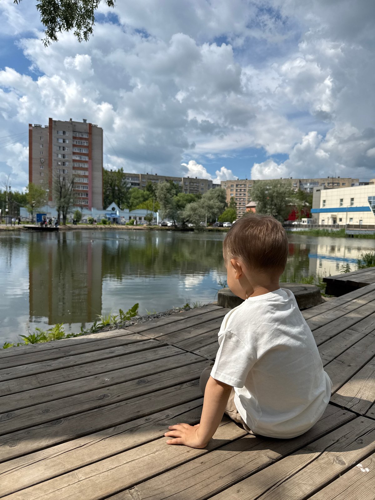 Mother and child enjoy morning outing by water in Rusanovo