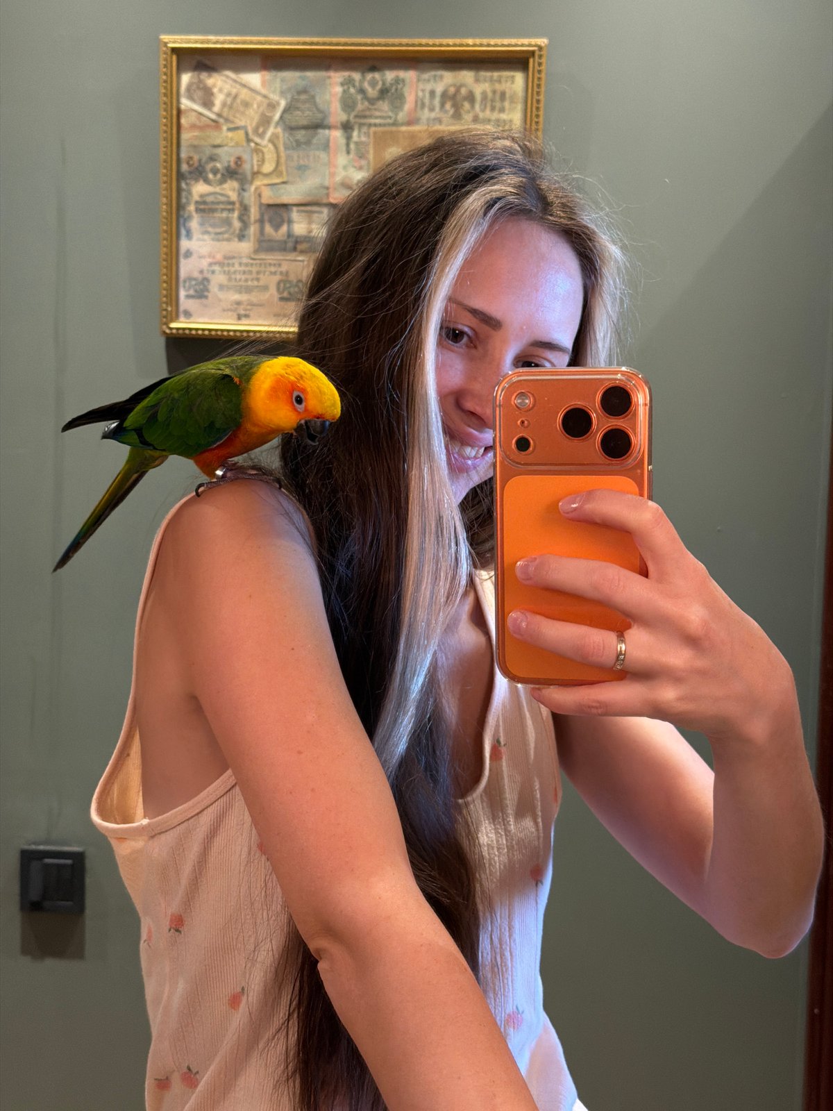Woman takes morning selfies with parrot in Khimki, Russia