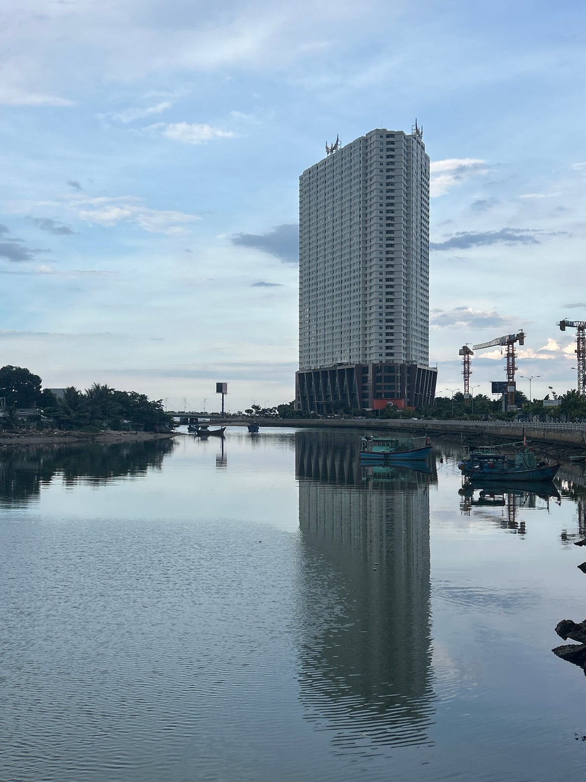Nha Trang's quiet fishing riverfront on a grey morning