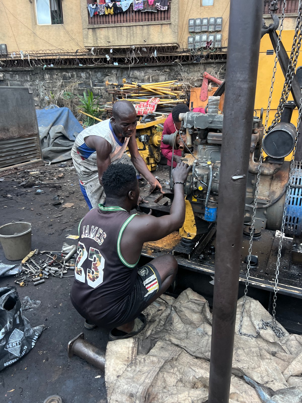 Generator repair work underway at outdoor workshop in Obosi, Nigeria