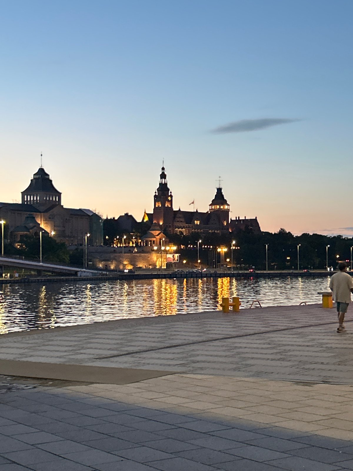 Szczecin waterfront at dusk — boats, spires, and science center