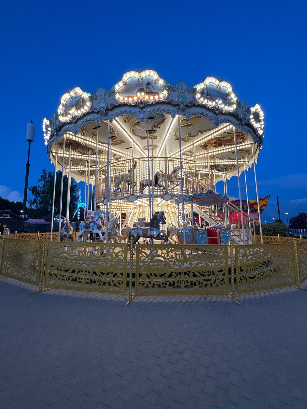 Ornate carousel spins at dusk in Novosibirsk