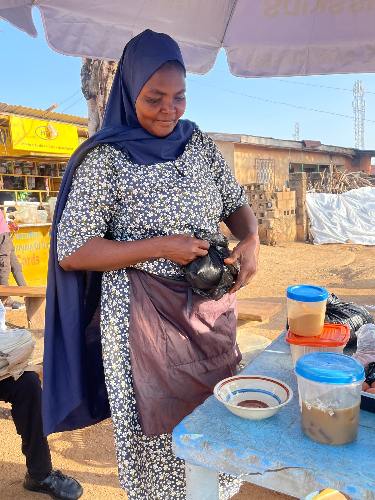 Morning food vendor serves customers at Jos market stall