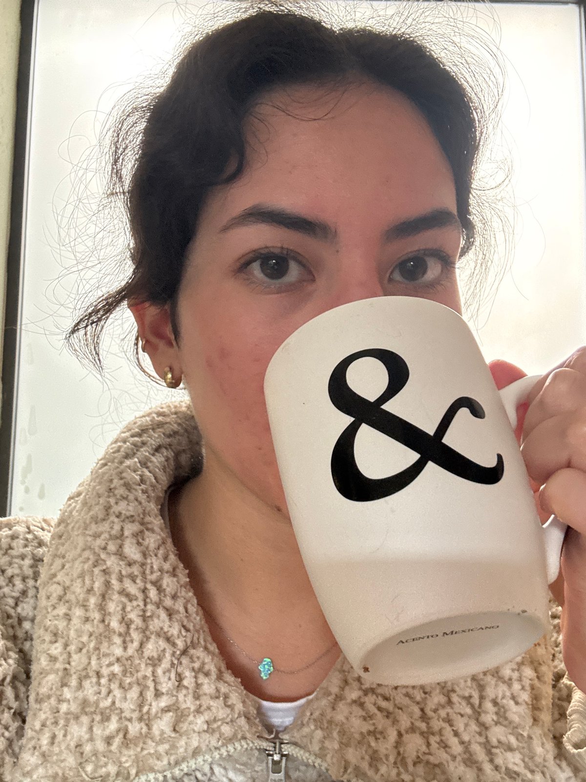 Woman drinks from mug and juice, reacts negatively in Puebla kitchen