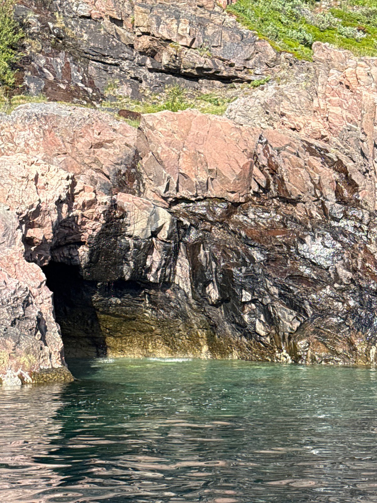 Exploring Teriberka's sea caves and coastline by boat