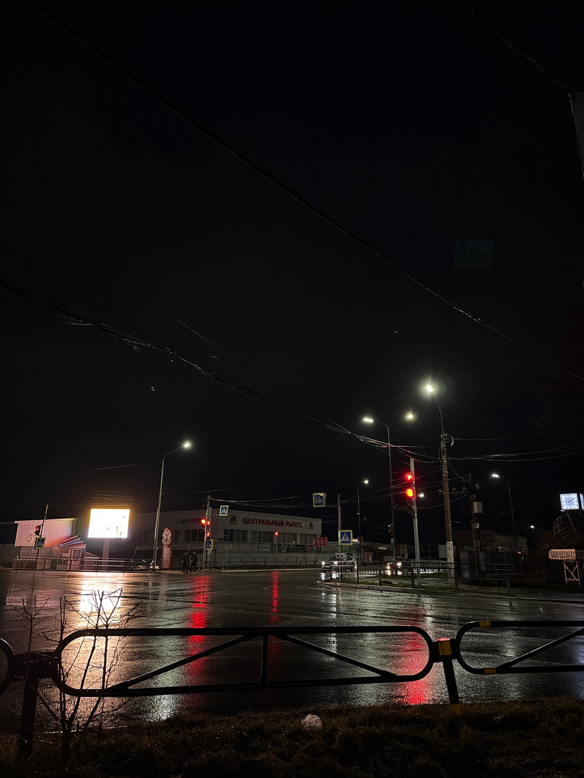 Wet streets reflect light after rain in Chaikovsky, Russia