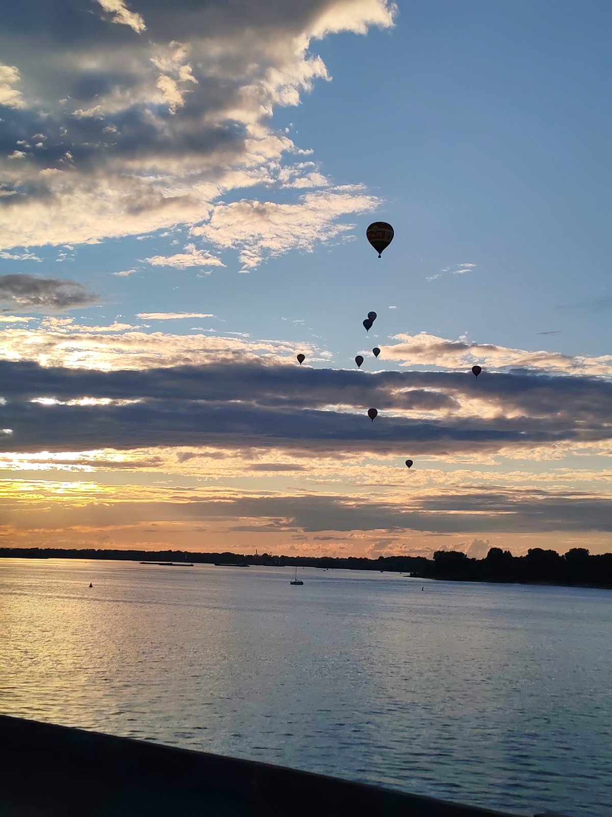 Sunset stroll along the Volga with hot air balloons overhead